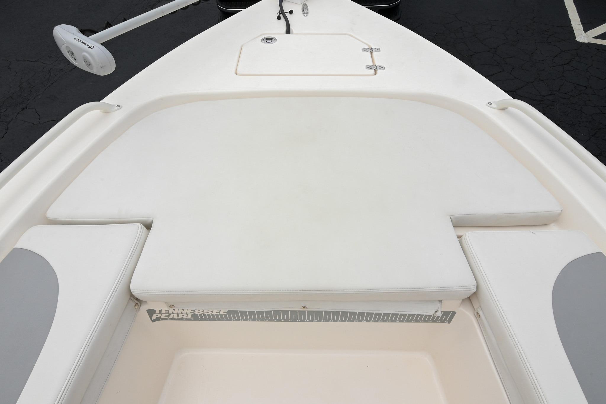 2021 Pathfinder 2200 TRS boat deck with cushioned seating and storage compartment.
