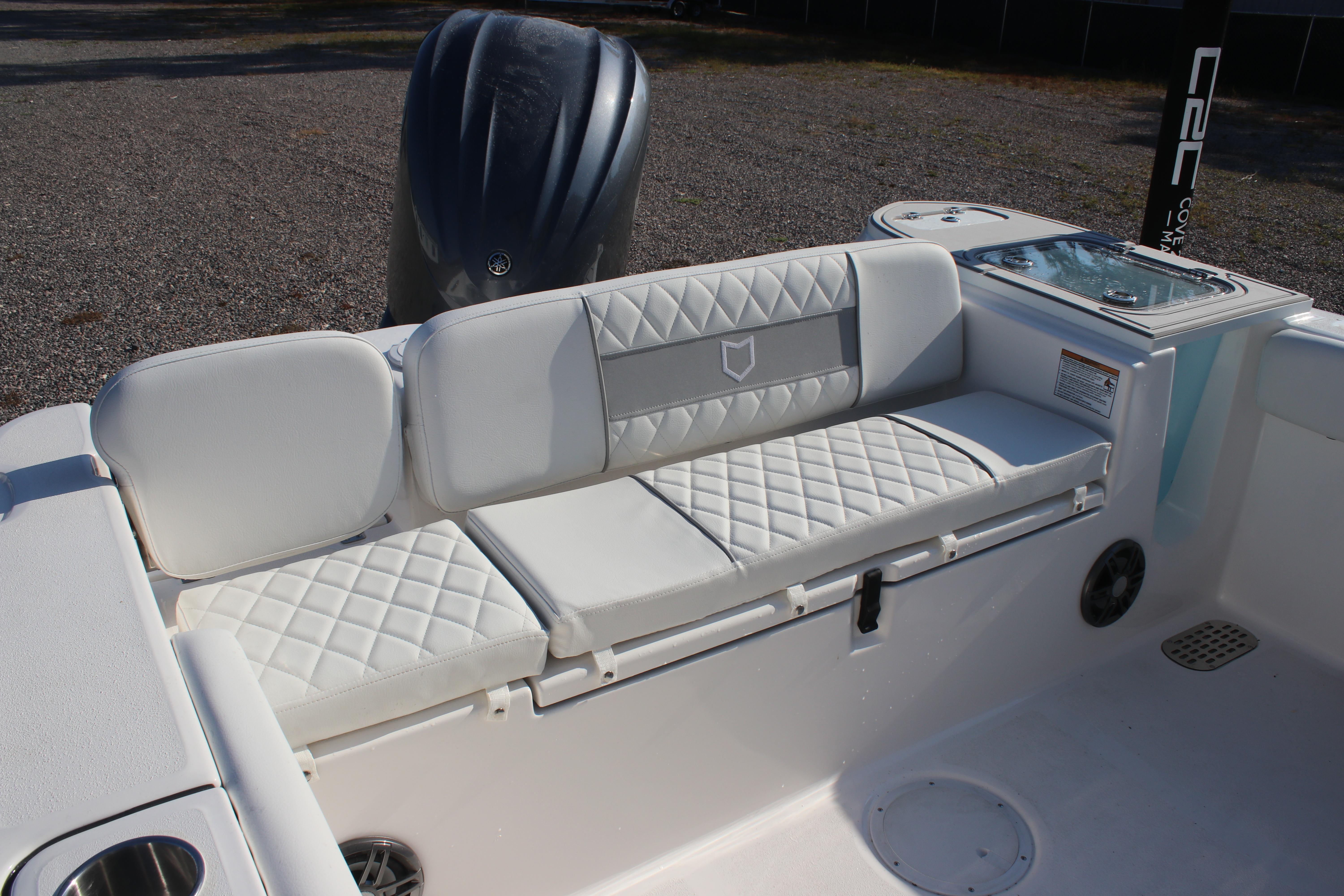 2026 Sea Fox 248 Commander boat with white cushioned seating and sleek design.