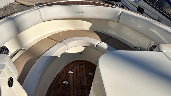 2014 Chris-Craft 28 LAUNCH boat with spacious seating and wooden deck.