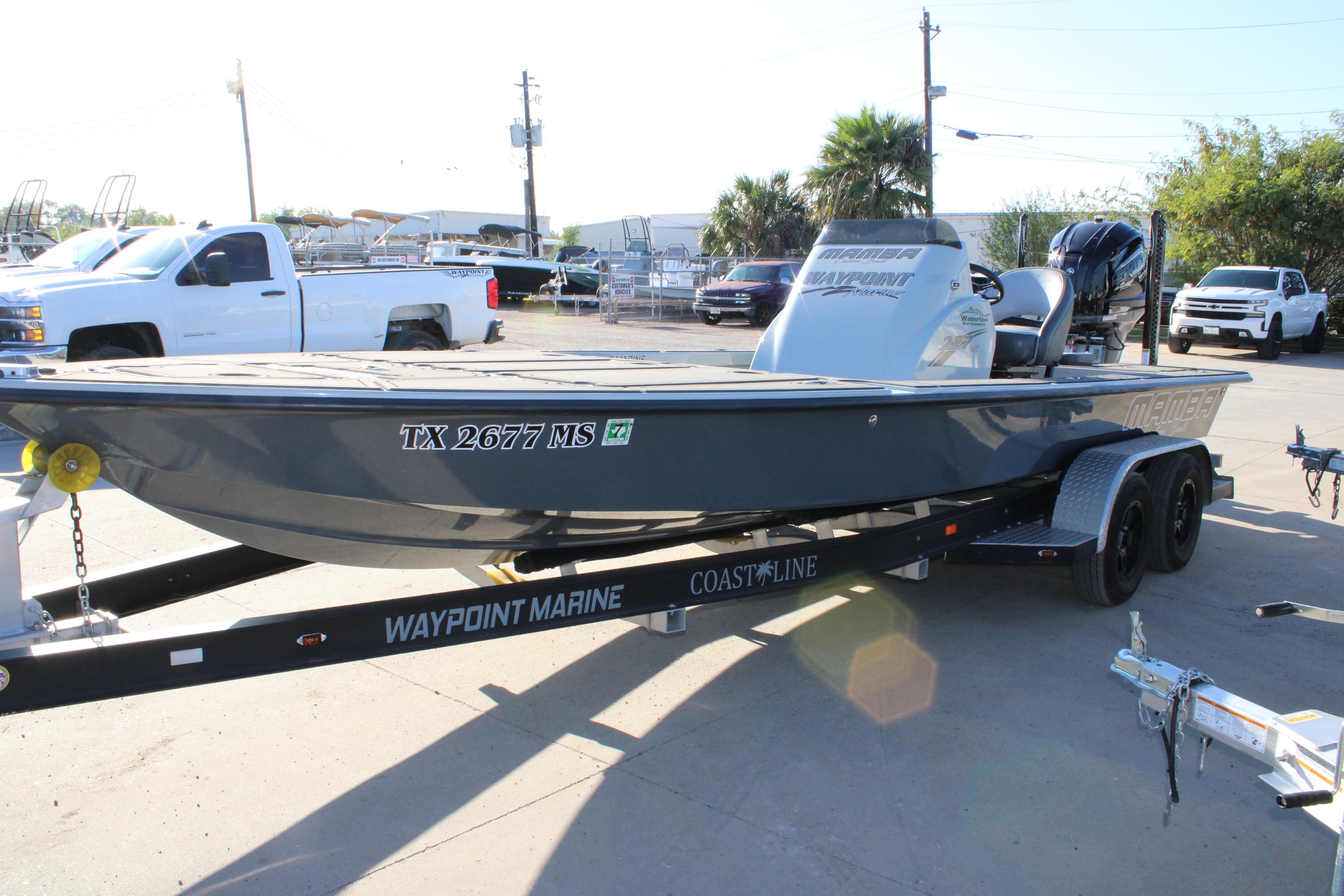 2025 Mamba 227VX boat on trailer, parked in a marina lot.