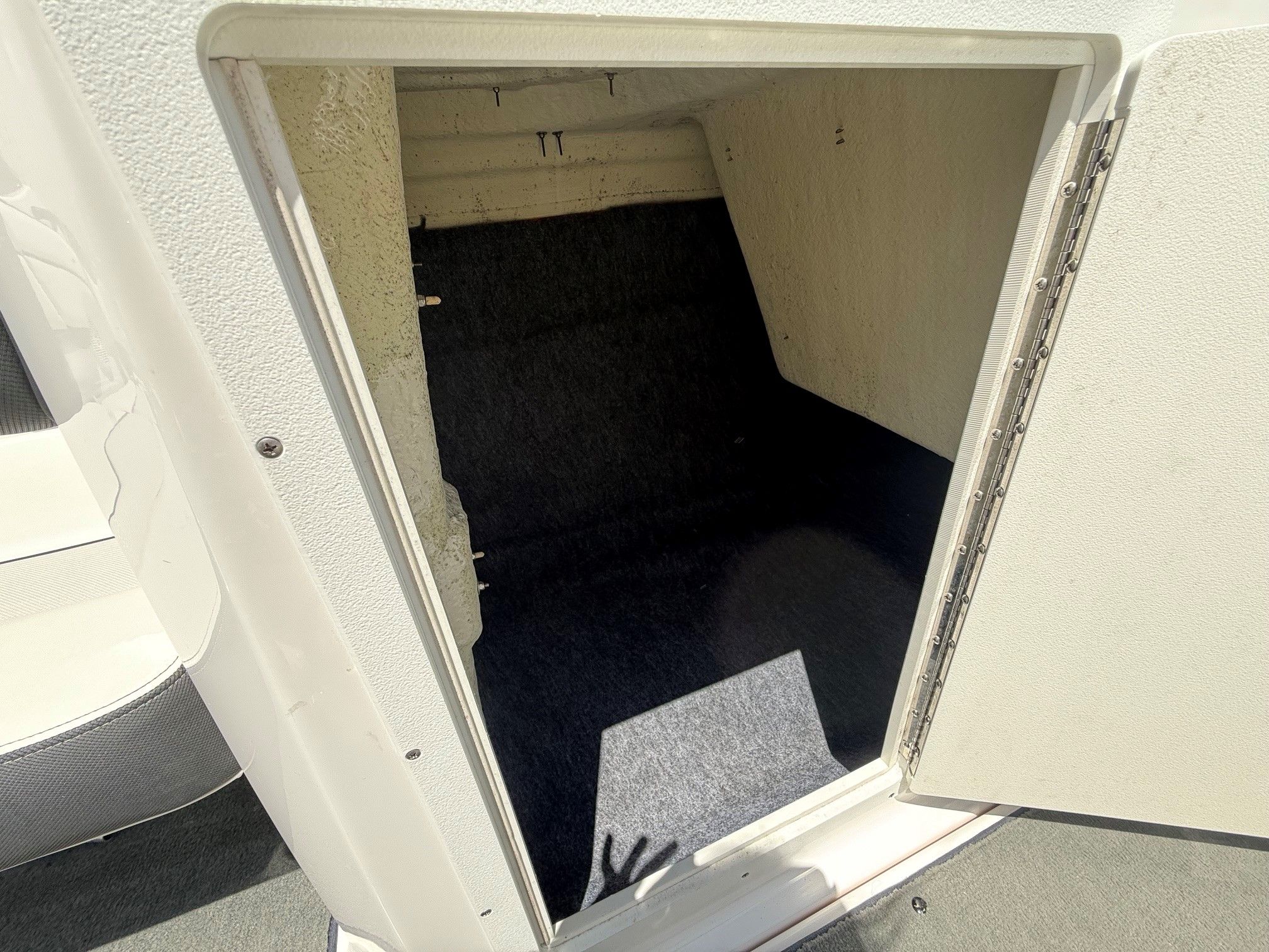 Open storage compartment on a Yamaha SX210 boat.