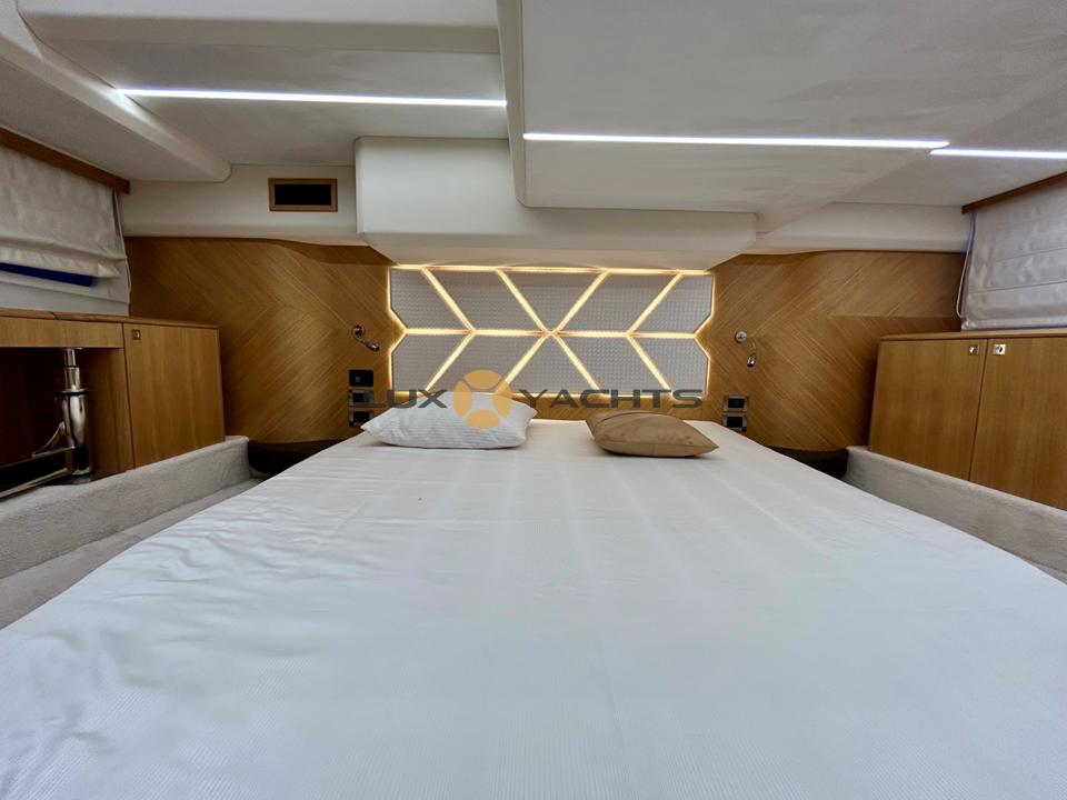 Luxurious bedroom interior of 2021 Galeon 400 Fly yacht with modern design.