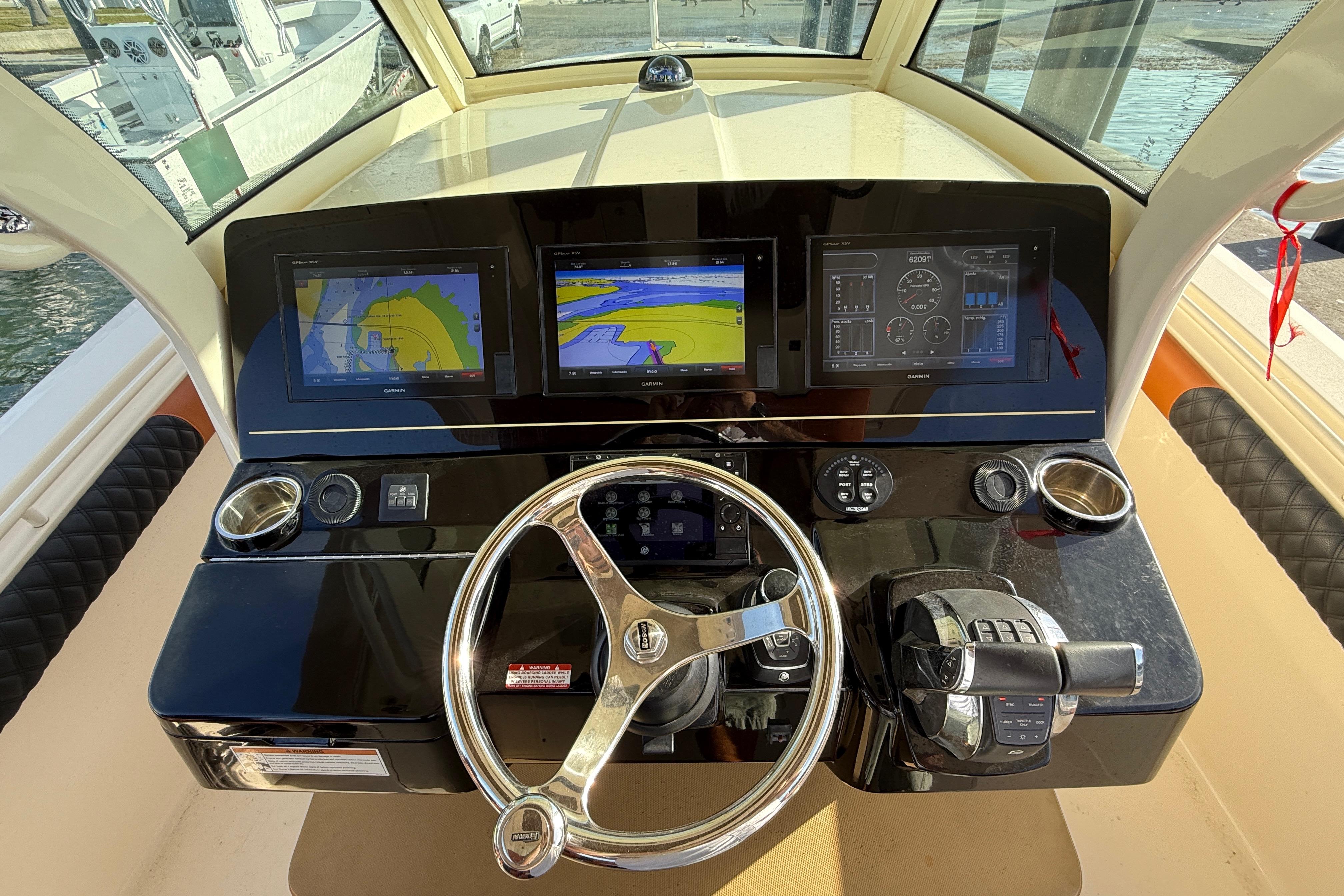 2019 Scout 355 LXF boat dashboard with navigation screens and steering wheel.