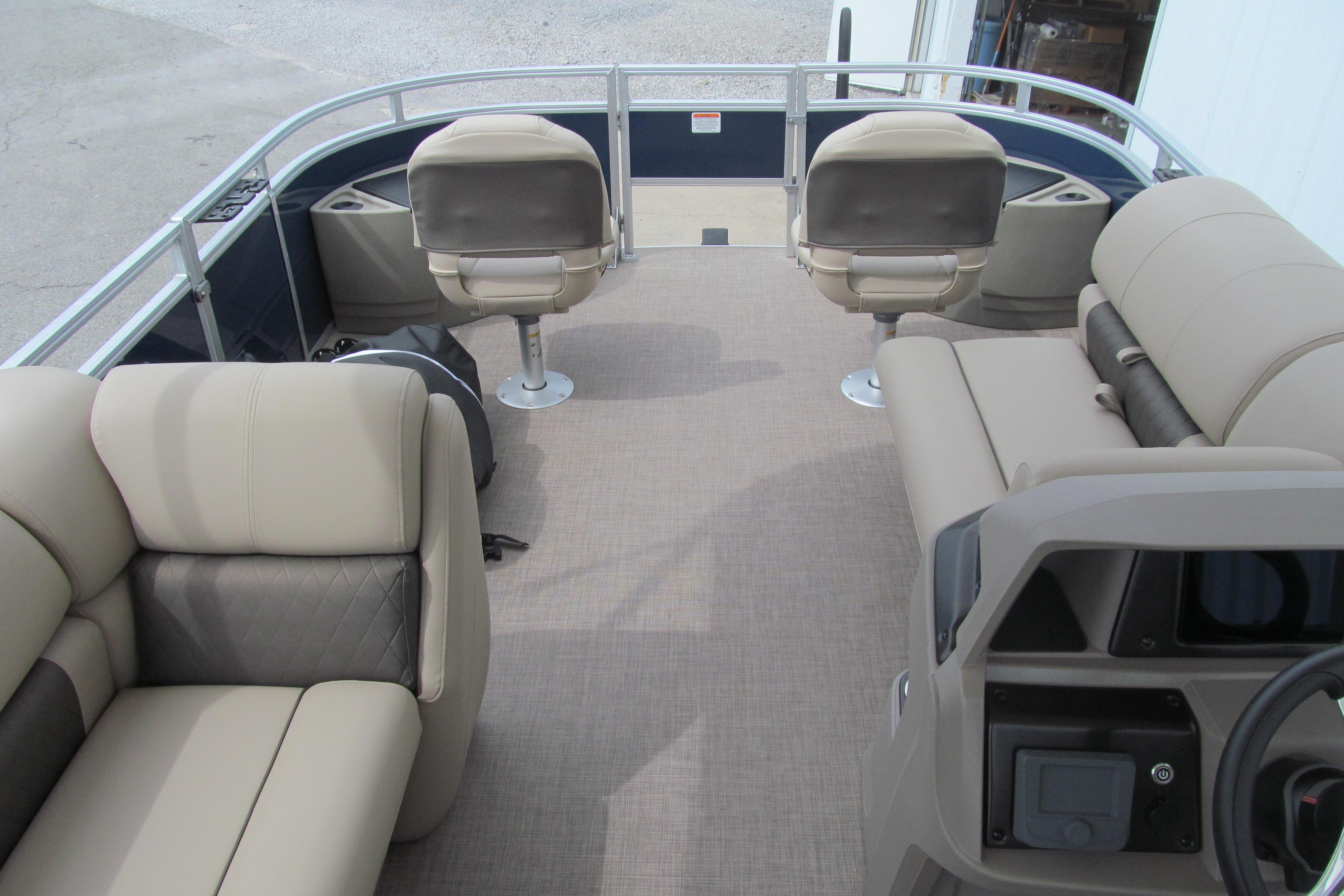 2024 Sun Tracker Fishin' Barge 20 DLX interior with beige seating and spacious layout.