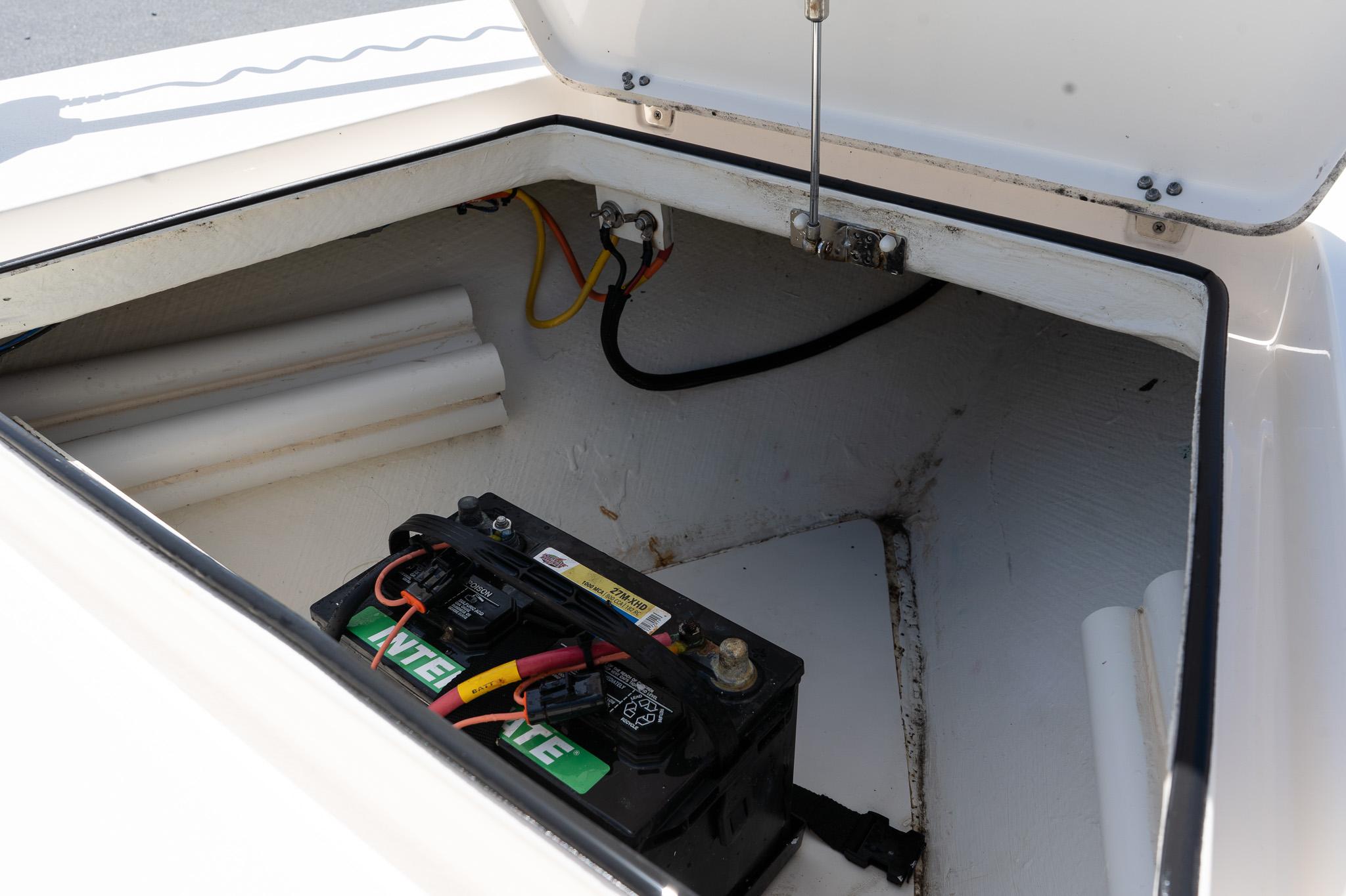 2023 Maverick 18 HPX-V boat battery compartment with wiring and storage space.