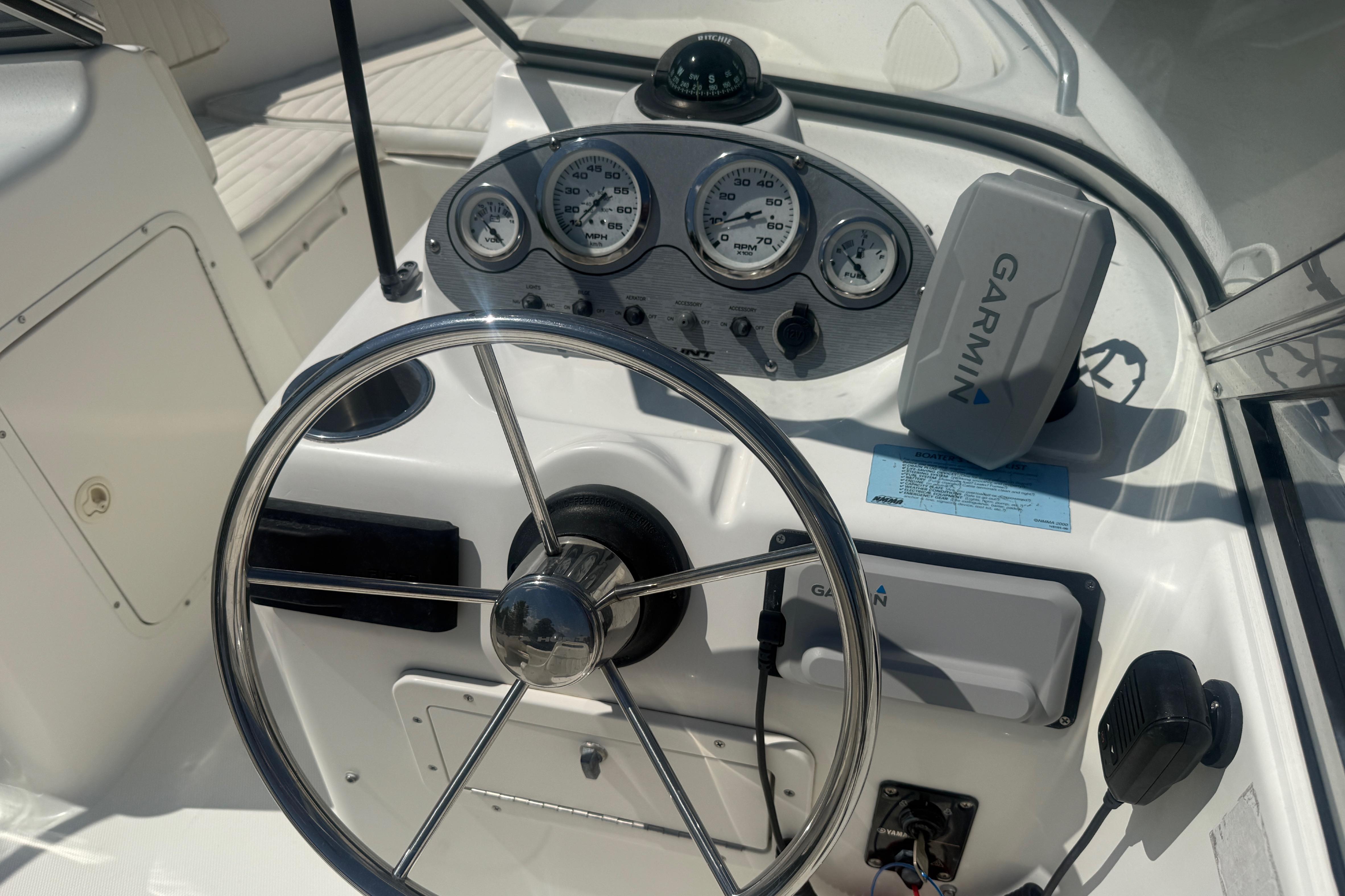 Steering console of a 2006 Sea Hunt Escape 200 boat with Garmin navigation system.