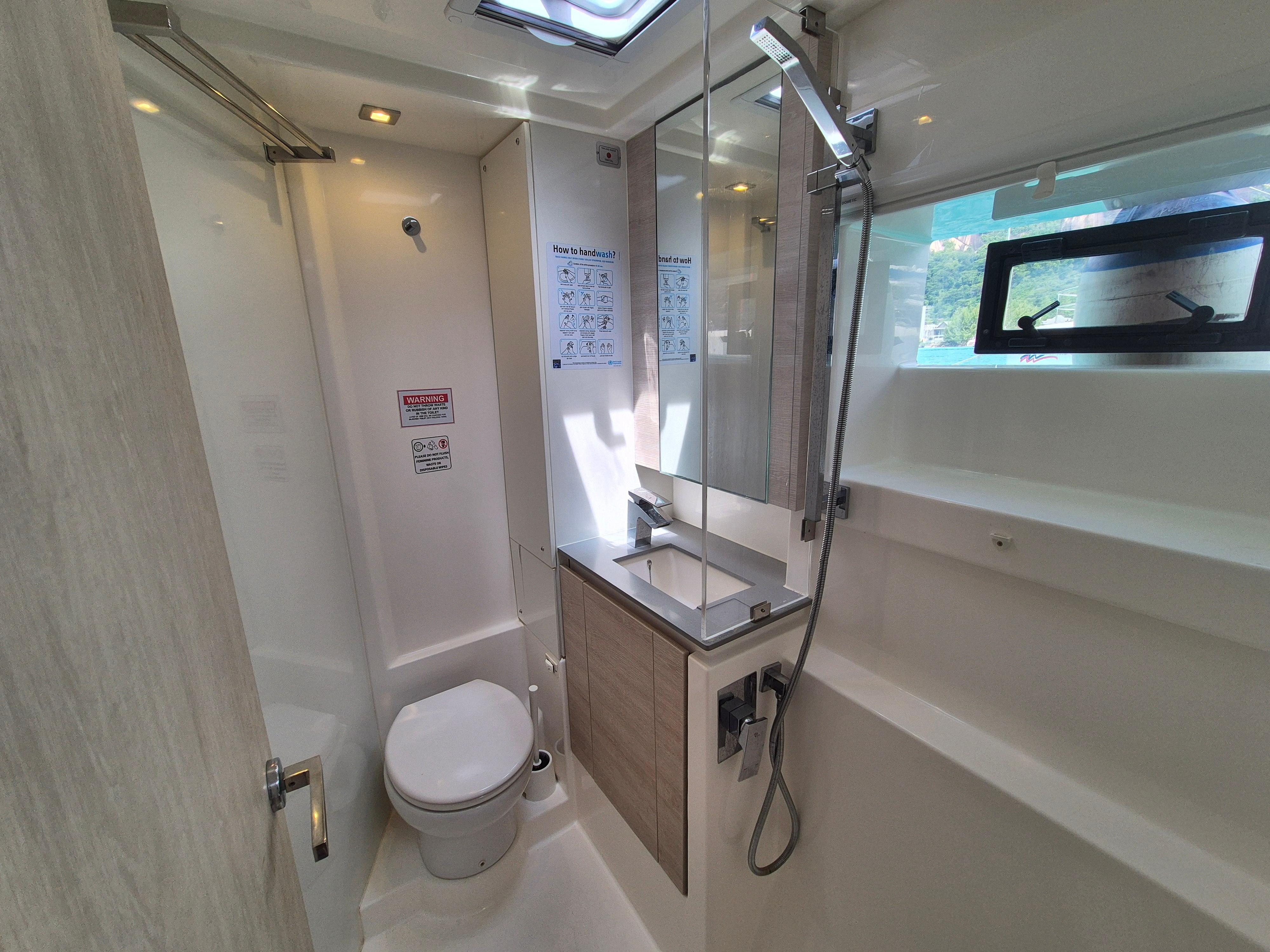 Modern bathroom in a 2020 Leopard 50 yacht, featuring sleek fixtures and natural lighting.