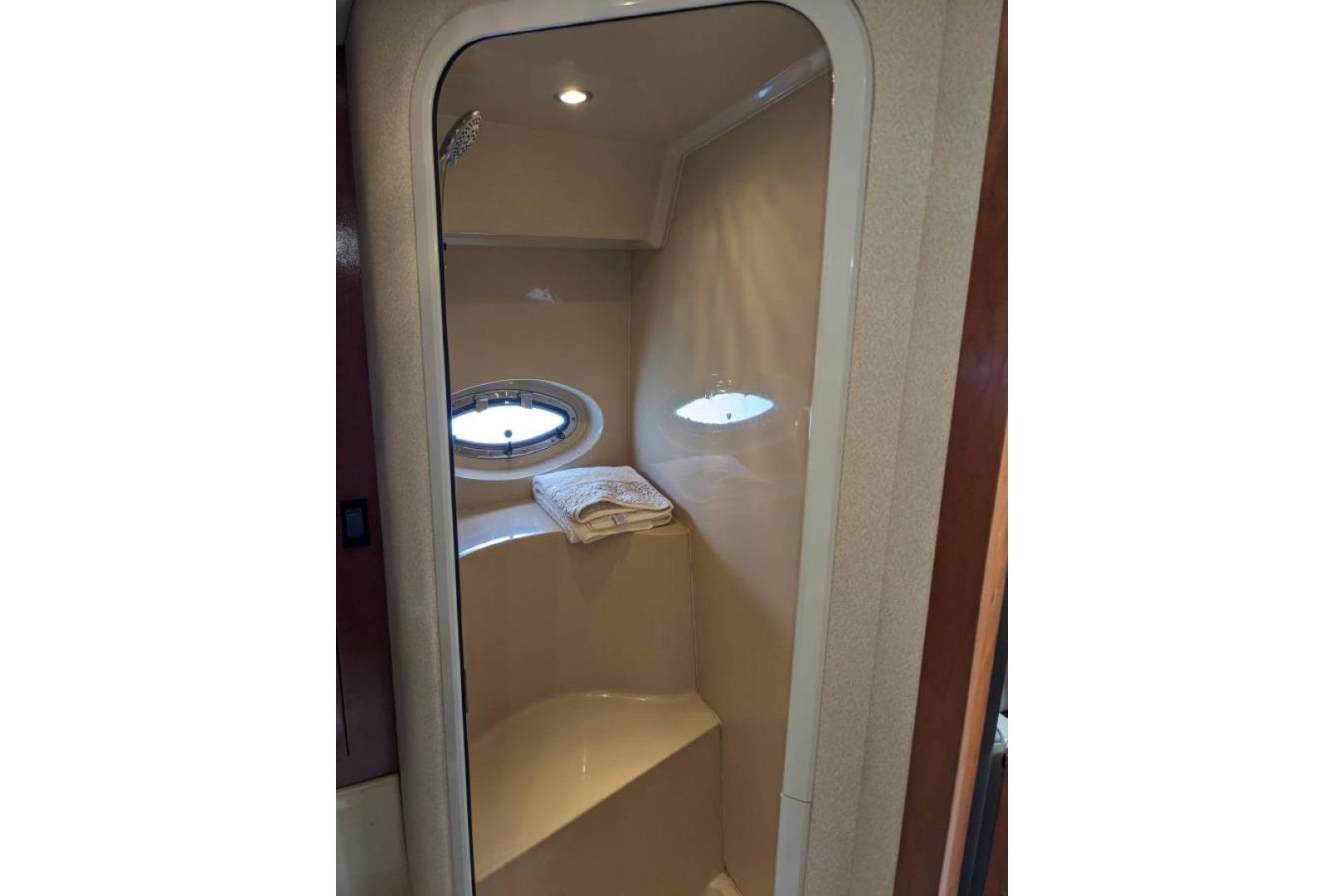 2003 Cruisers 3970 yacht shower with porthole and towel.