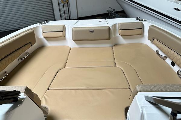 2024 Bayliner DX 2250 boat interior with beige seating and spacious layout.