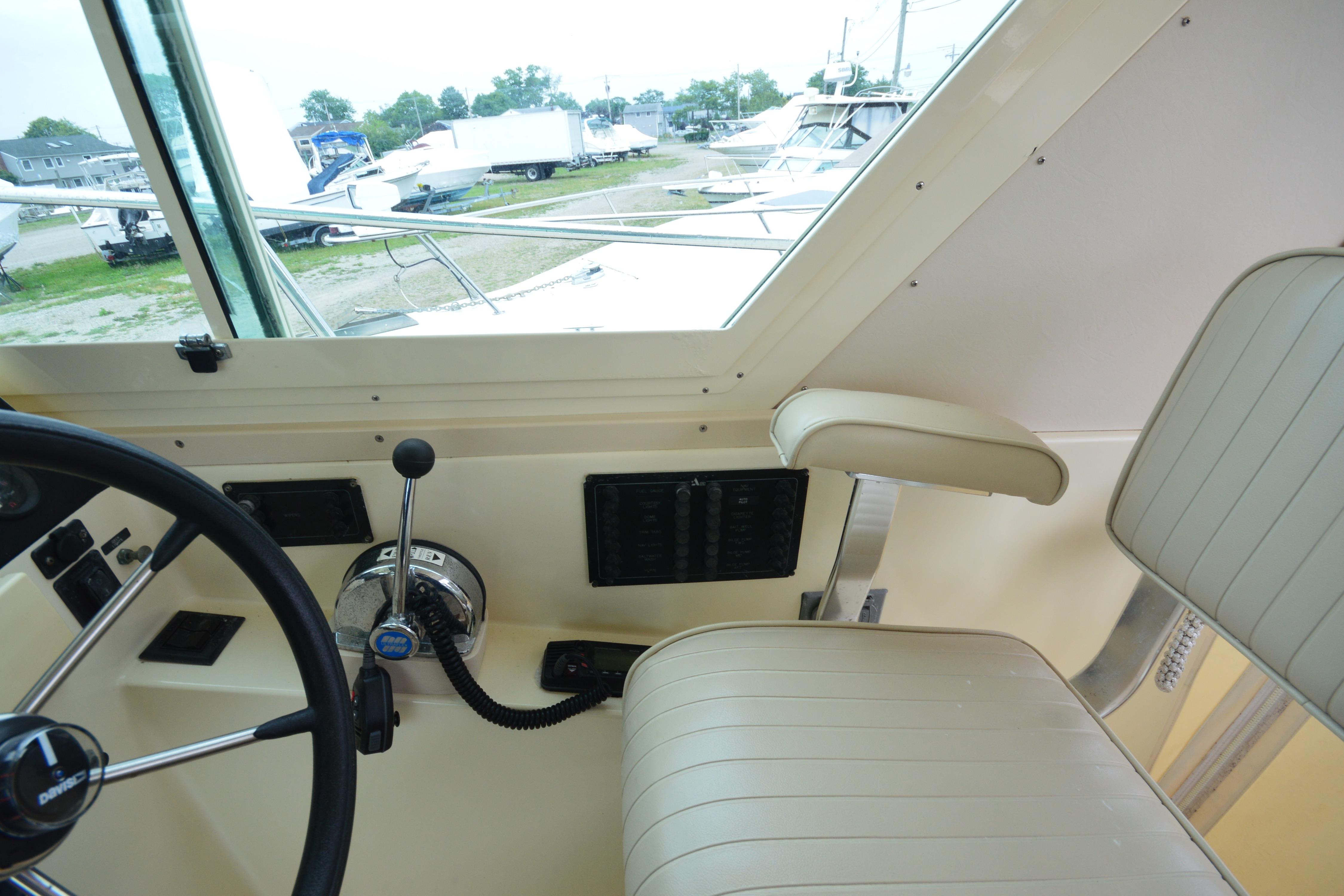 Interior helm of 2001 Albin 28 Tournament Express boat with steering wheel and controls.