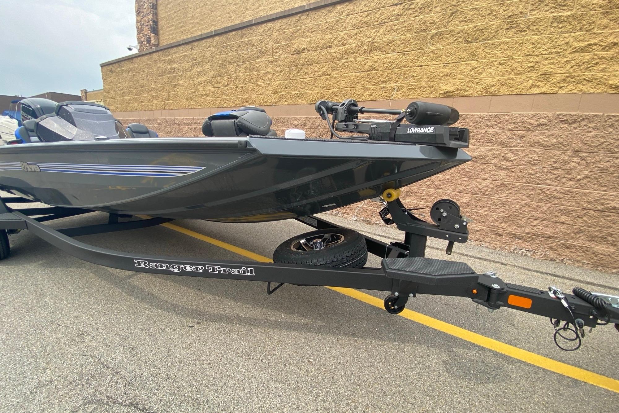 2026 Ranger RT178 boat on trailer, featuring Lowrance equipment, parked by a brick wall.