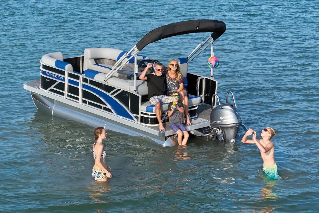 2026 Bennington S 20 SSR pontoon boat with people enjoying water activities.