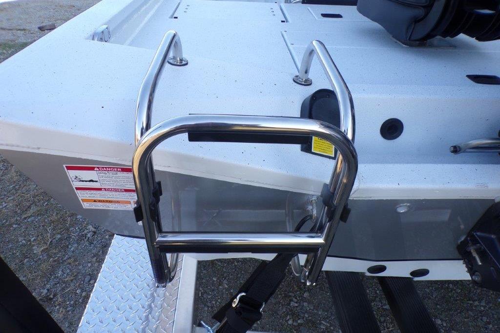 2026 Xpress H20B Bay boat with stainless steel ladder and safety warning labels.
