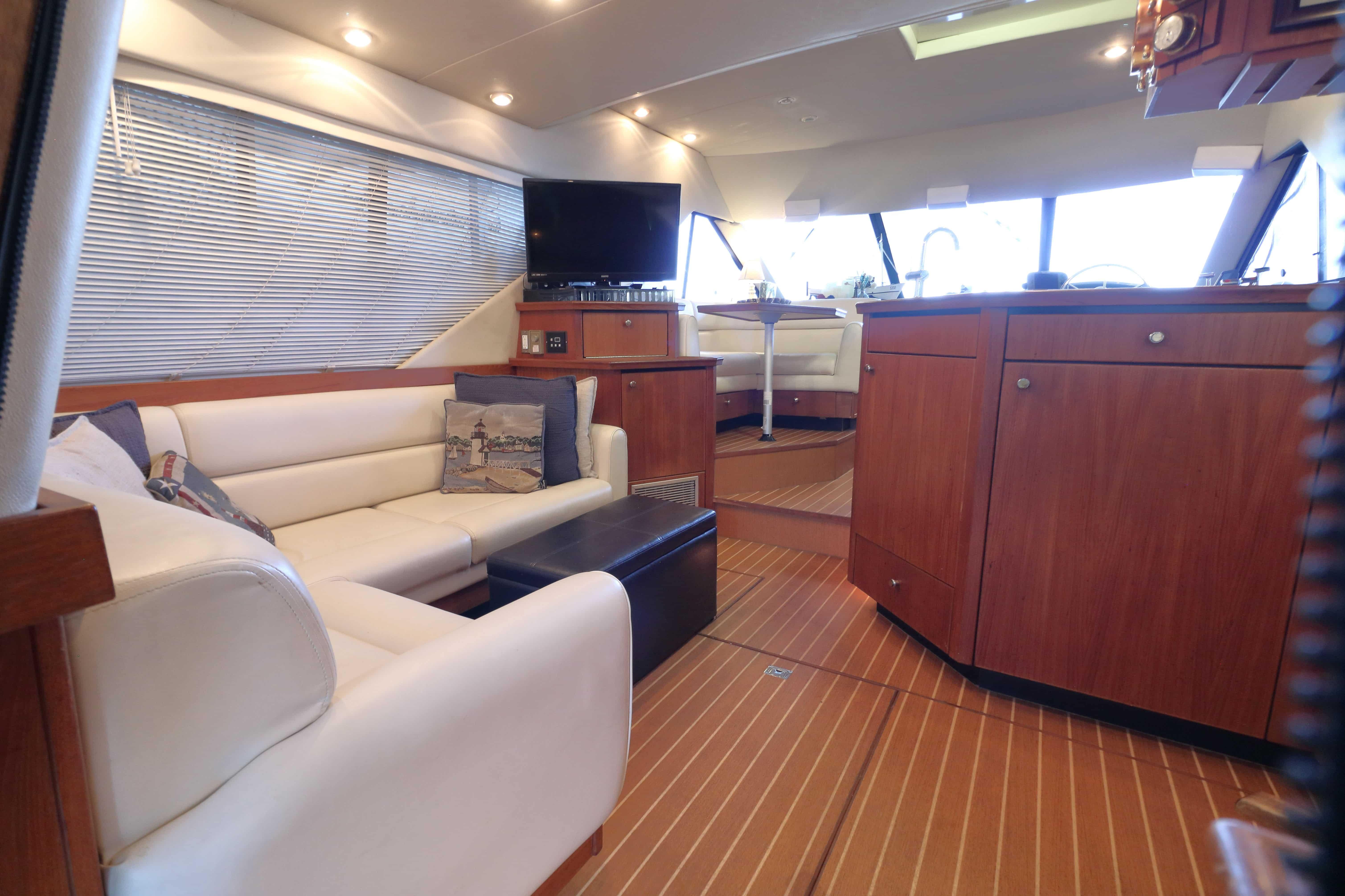 Luxurious interior of 1995 Bayliner 3988 Command Bridge Motoryacht with elegant seating and wood finishes.
