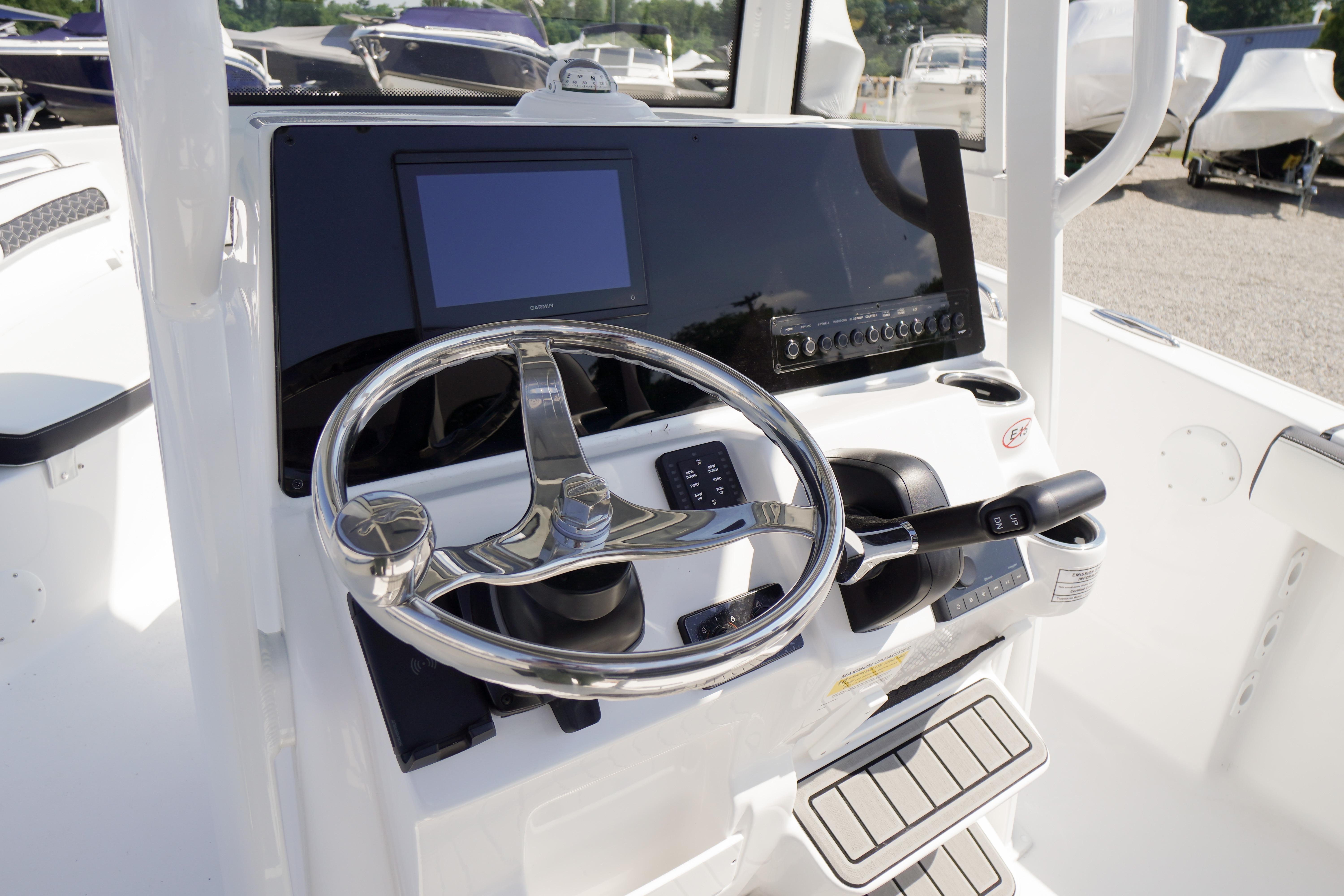 2026 Tidewater 220 CC Adventure boat console with steering wheel and control panel.