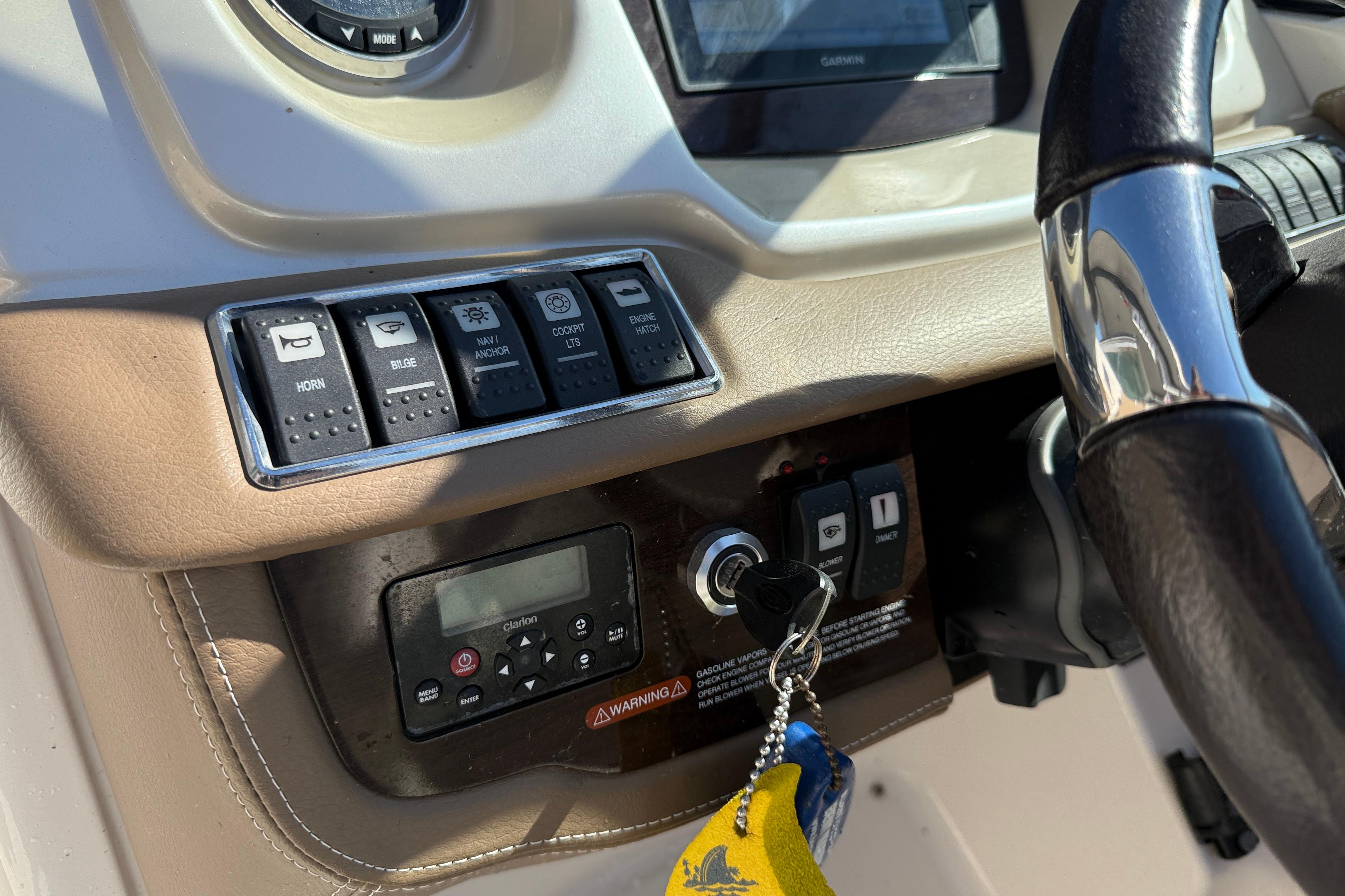 2014 Chaparral 264 Sunesta dashboard with controls, steering wheel, and ignition keys.