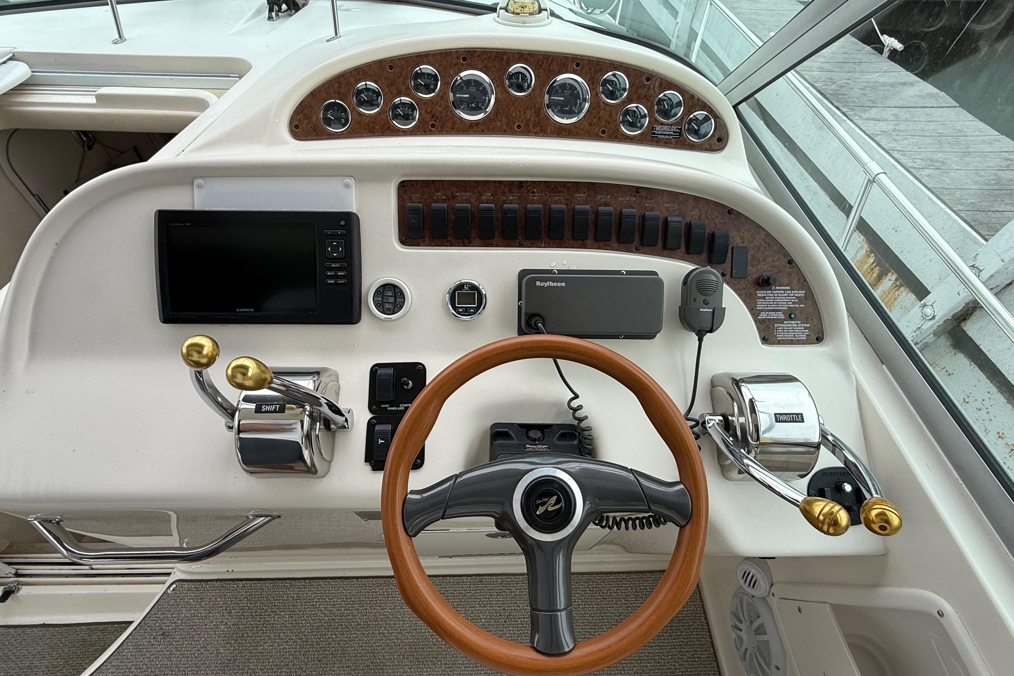 1999 Sea Ray Sundancer 310 helm with gauges, controls, and navigation equipment.