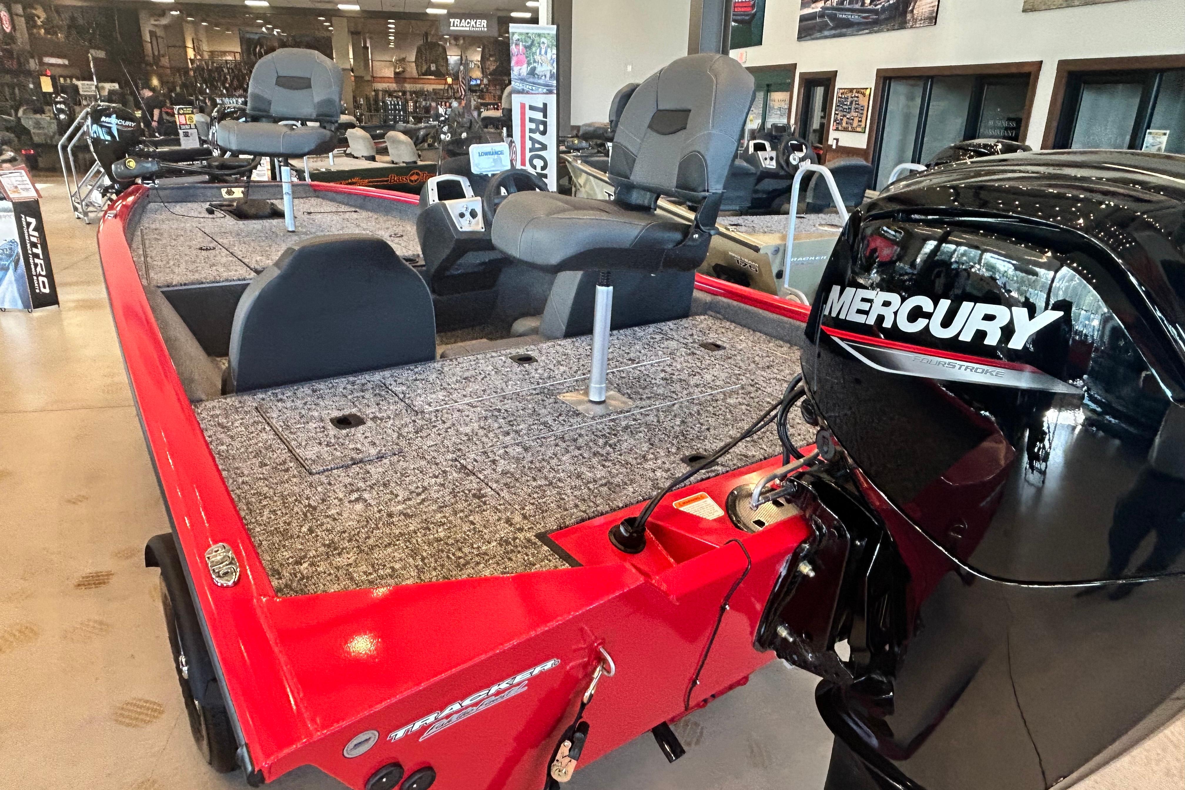 2026 Tracker Pro Team 175 boat with Mercury engine in showroom.