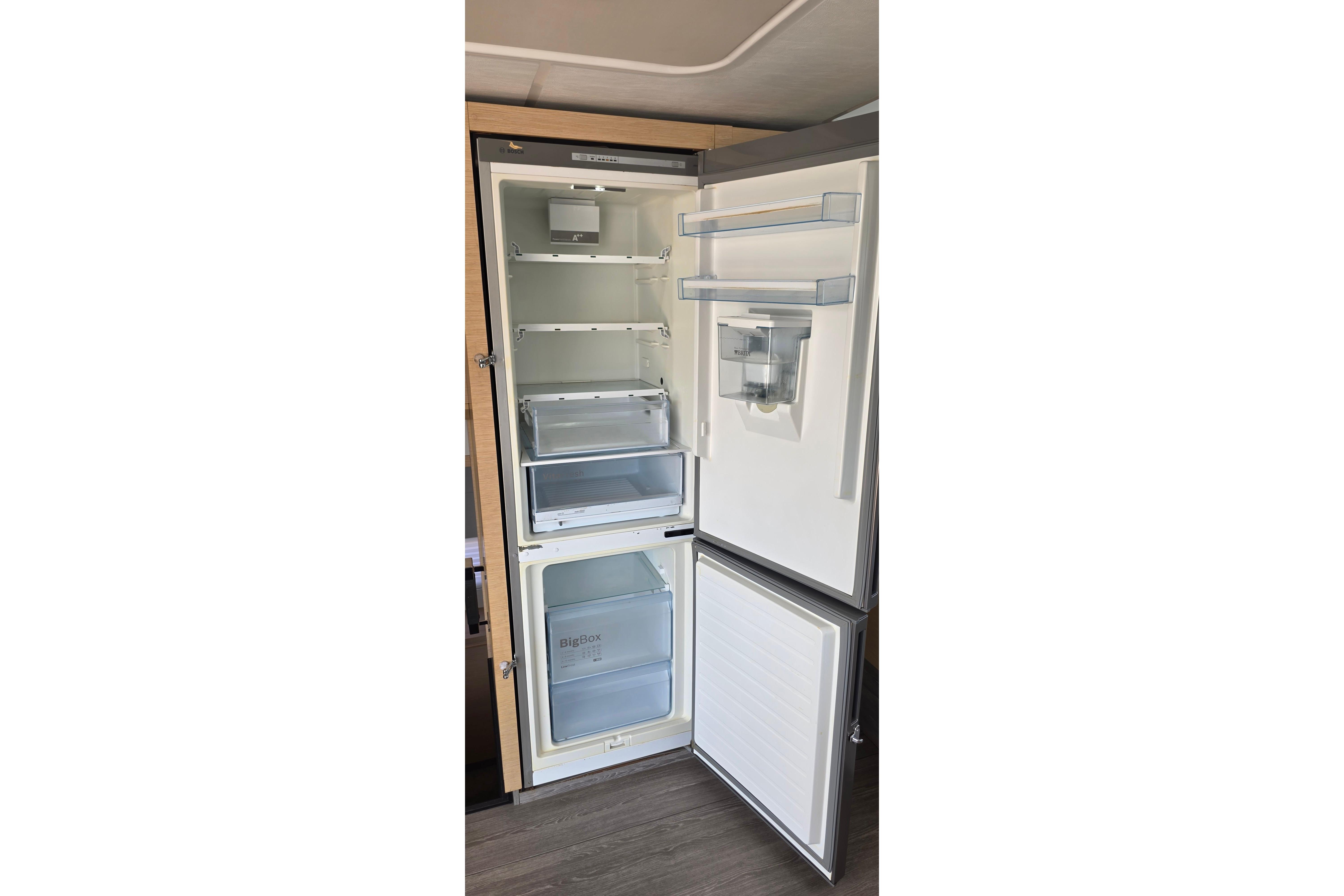 Open refrigerator inside 2018 Fountaine Pajot Motor Yacht 44, showcasing spacious interior and storage compartments.