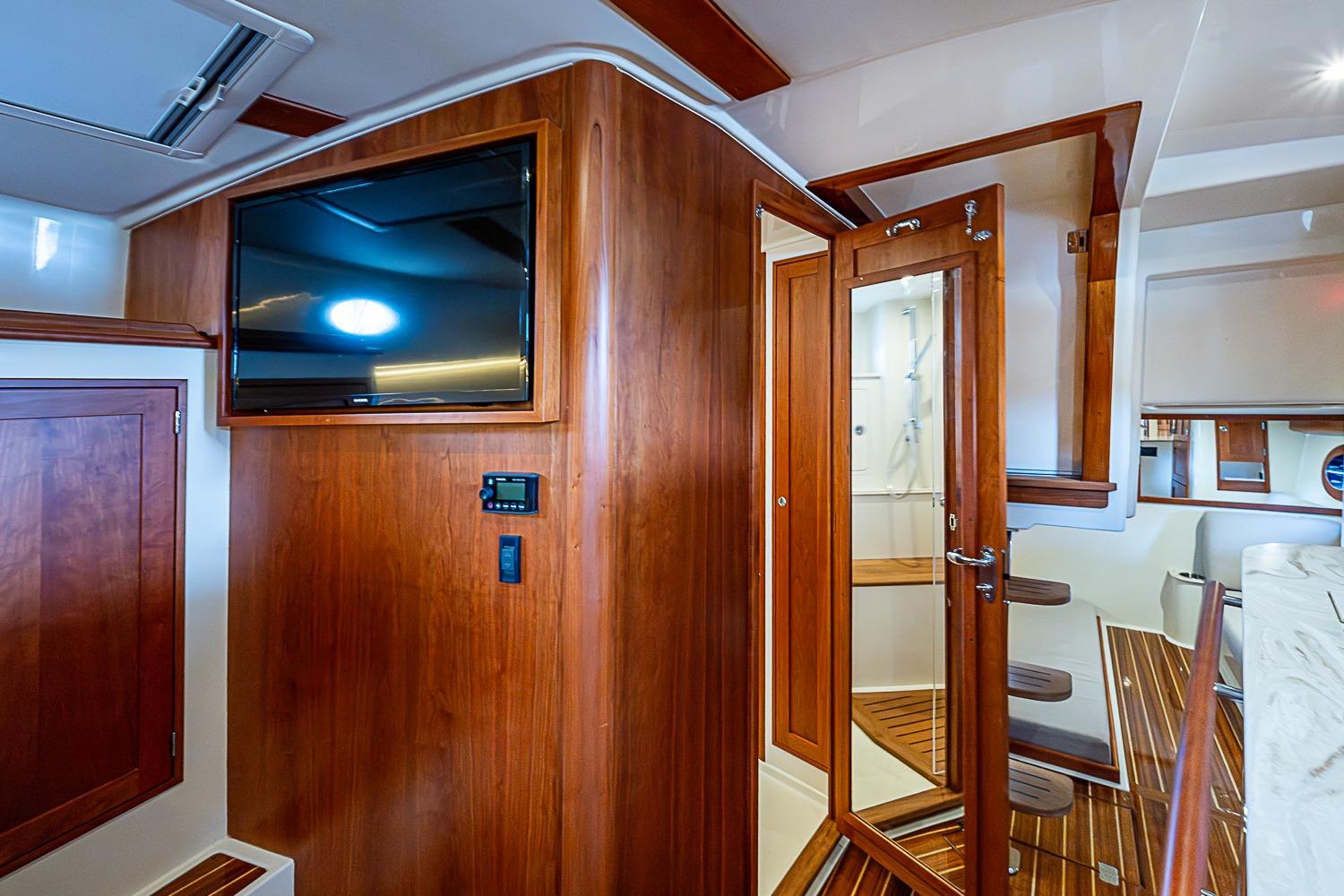 Interior of 2023 Hinckley Sport Boat 40 X with wood paneling and modern amenities.