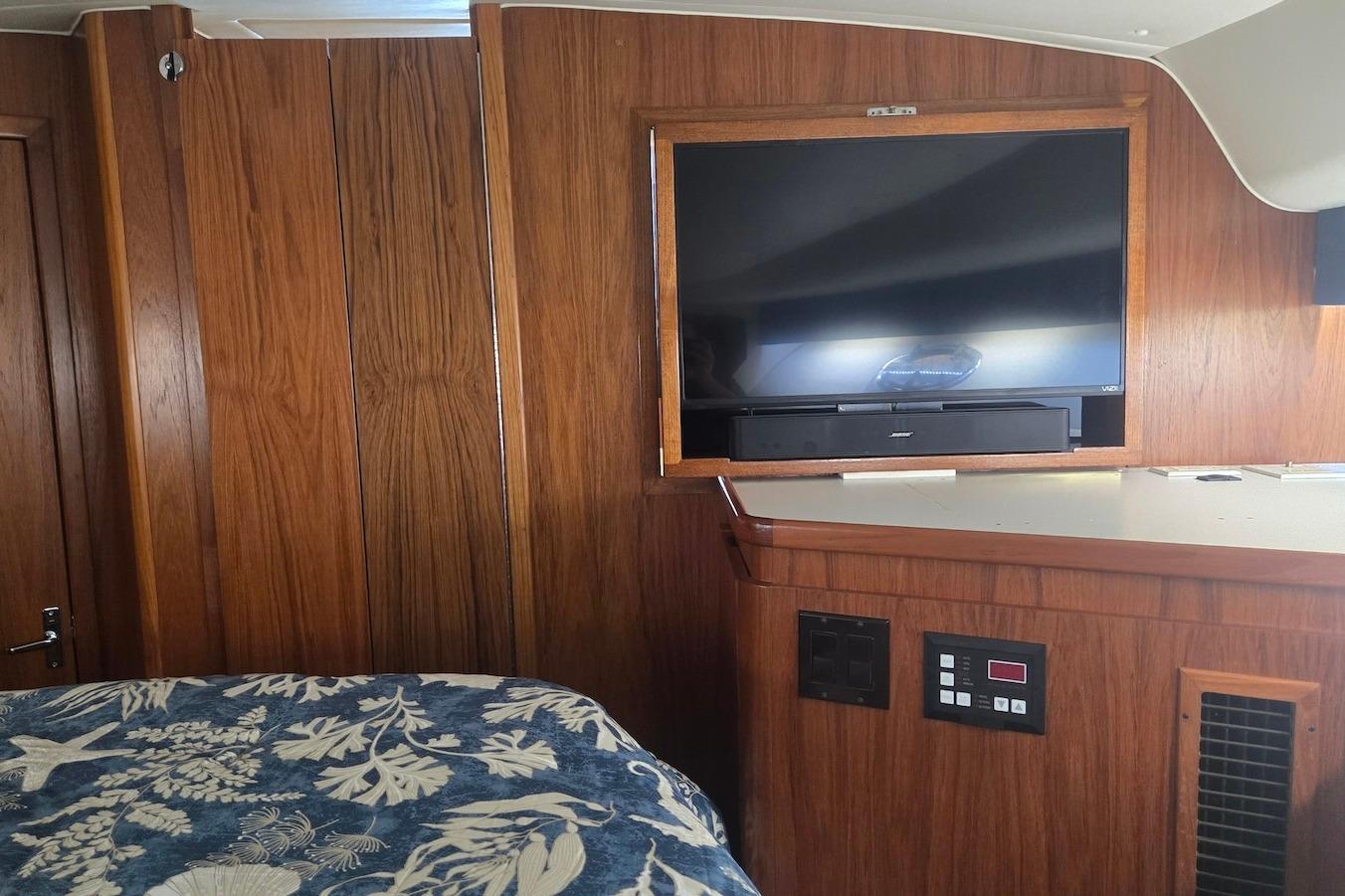 Interior of 1996 Tiara Yachts 3700 Open with TV and wood paneling.