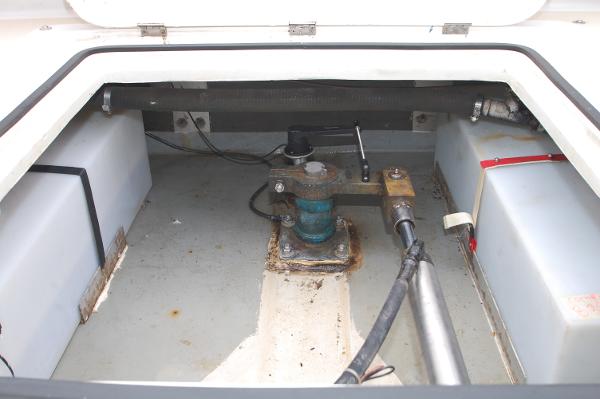 Interior view of a boat's engine compartment with tanks and mechanical parts.