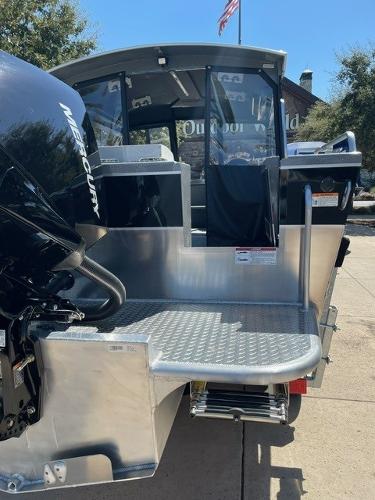 2024 Spartan 220 Maximus boat with Mercury engine, outdoor setting.