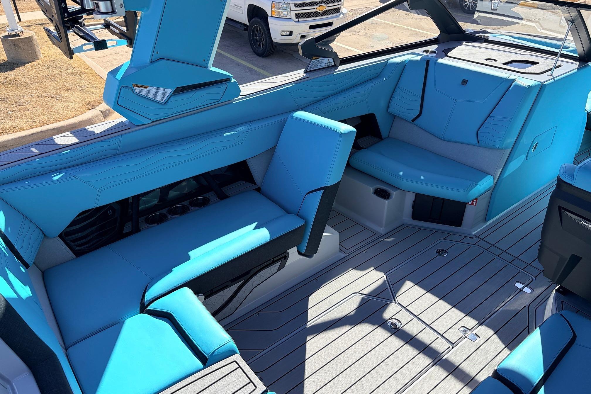 Interior of 2026 Nautique Super Air Nautique G23 with blue seating and modern design.