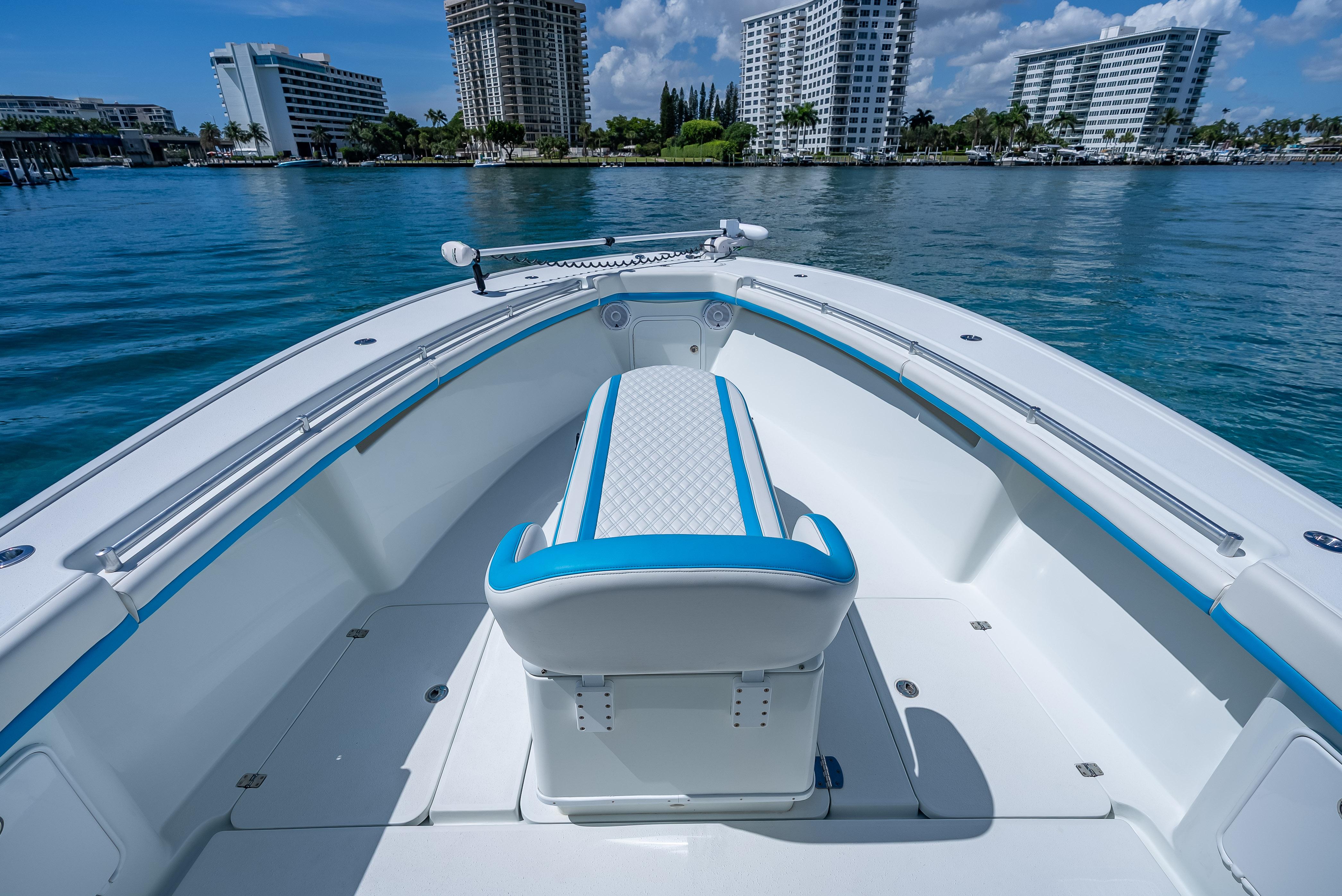 2016 Yellowfin 39 Offshore boat interior with blue accents, docked near modern buildings.