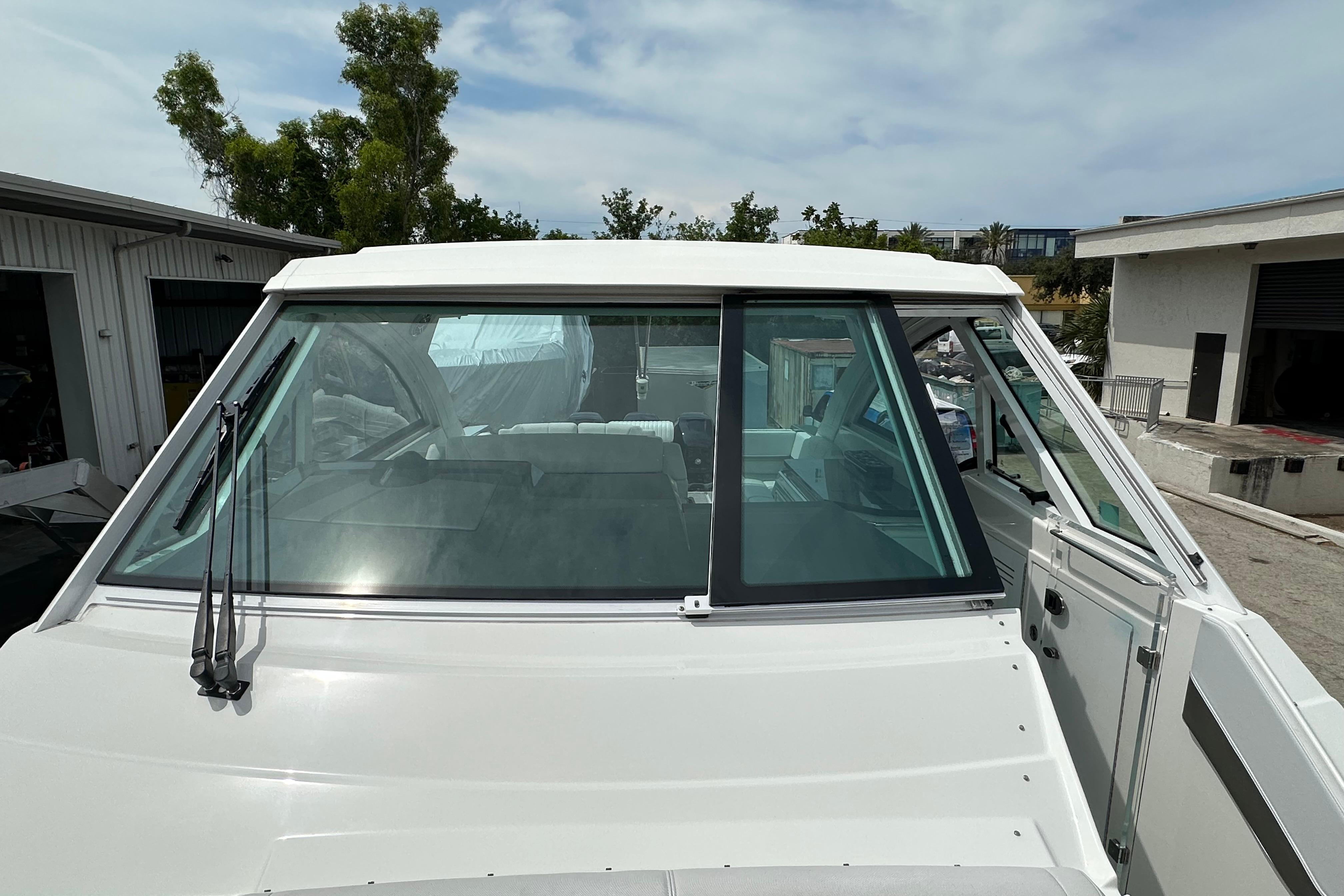 2021 Formula 380 Super Sport Crossover OB boat, front view with windshield and wipers.