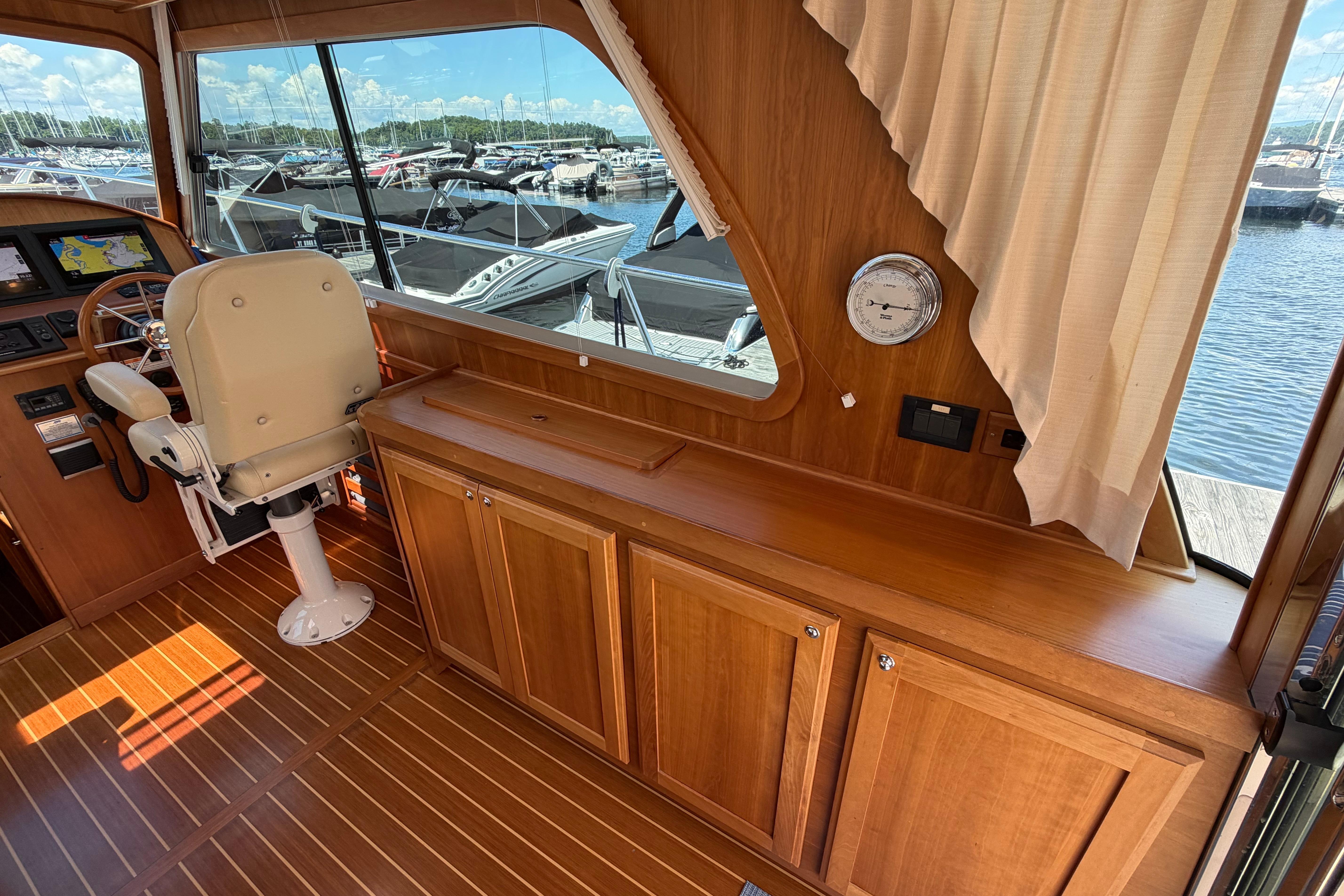 Interior of 2015 Sabre 38 Salon Express yacht with wooden cabinetry and helm station.