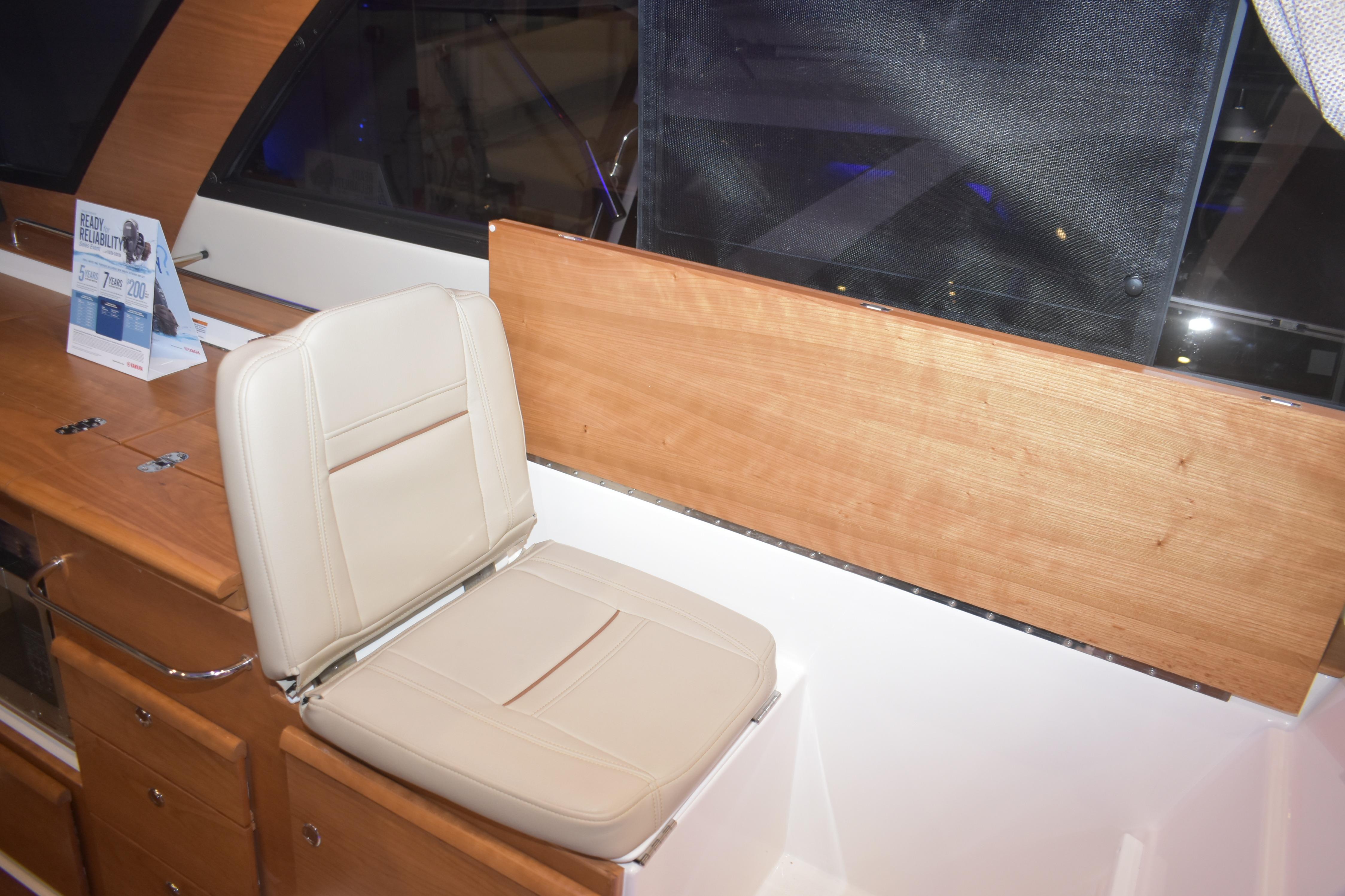 2026 Cutwater C-32 CB interior with beige seat and wooden paneling.