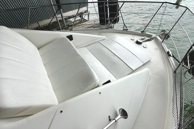 2004 Carver 360 Mariner boat deck with white seating and metal railings.