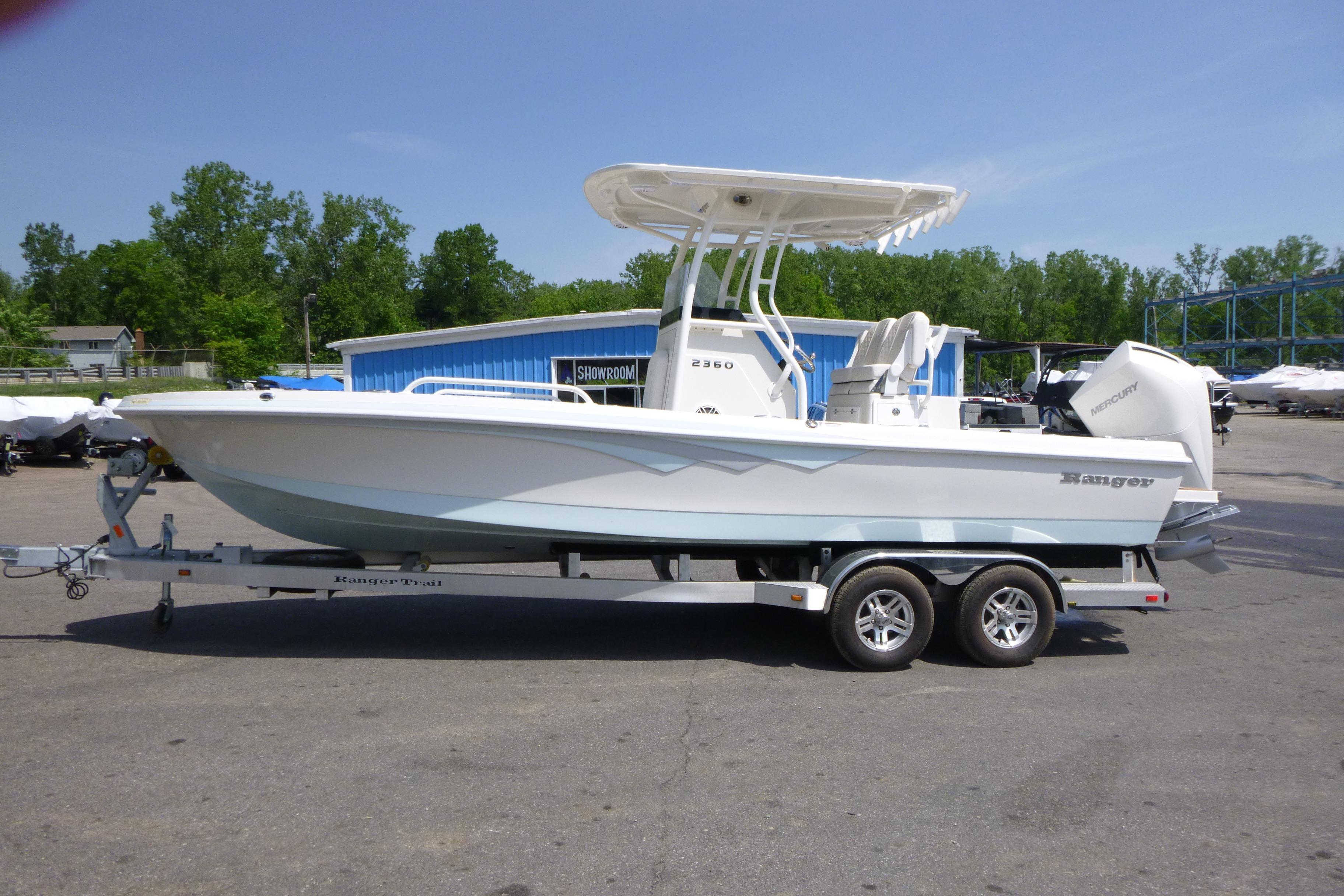 2024 Ranger 2360 Bay boat on trailer, parked outdoors near showroom.