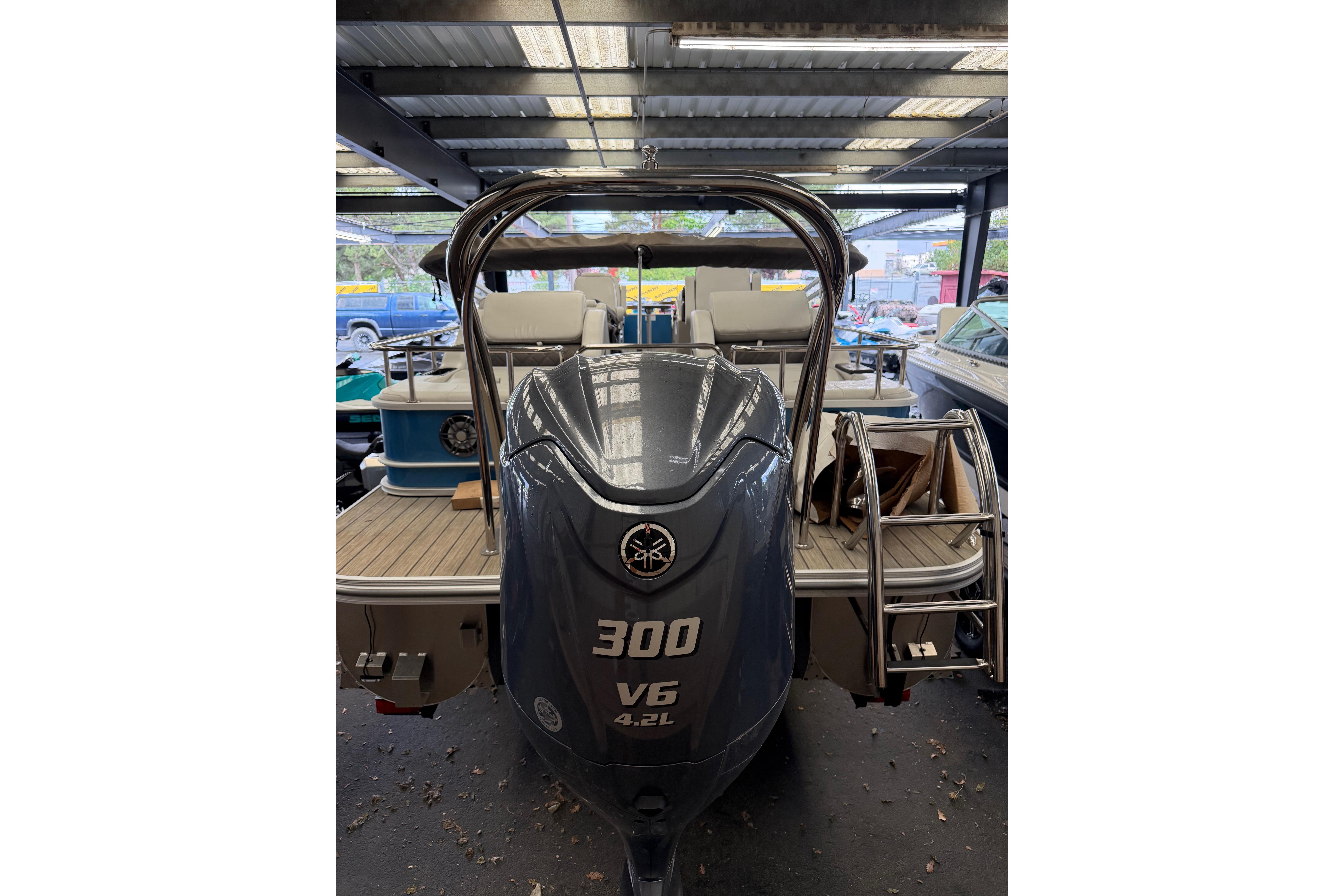 2024 SunCatcher Elite 326 SS DLX boat with powerful 300 V6 engine in showroom.