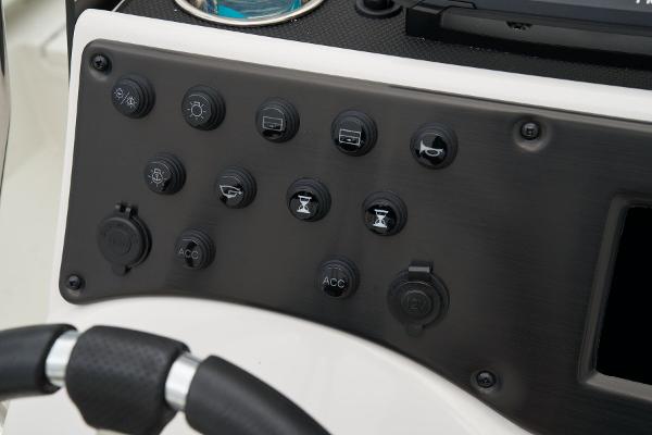 Manufacturer Provided Image: Manufacturer Provided Image: Control panel of 2025 Ranger RB210 boat with various switches and buttons.