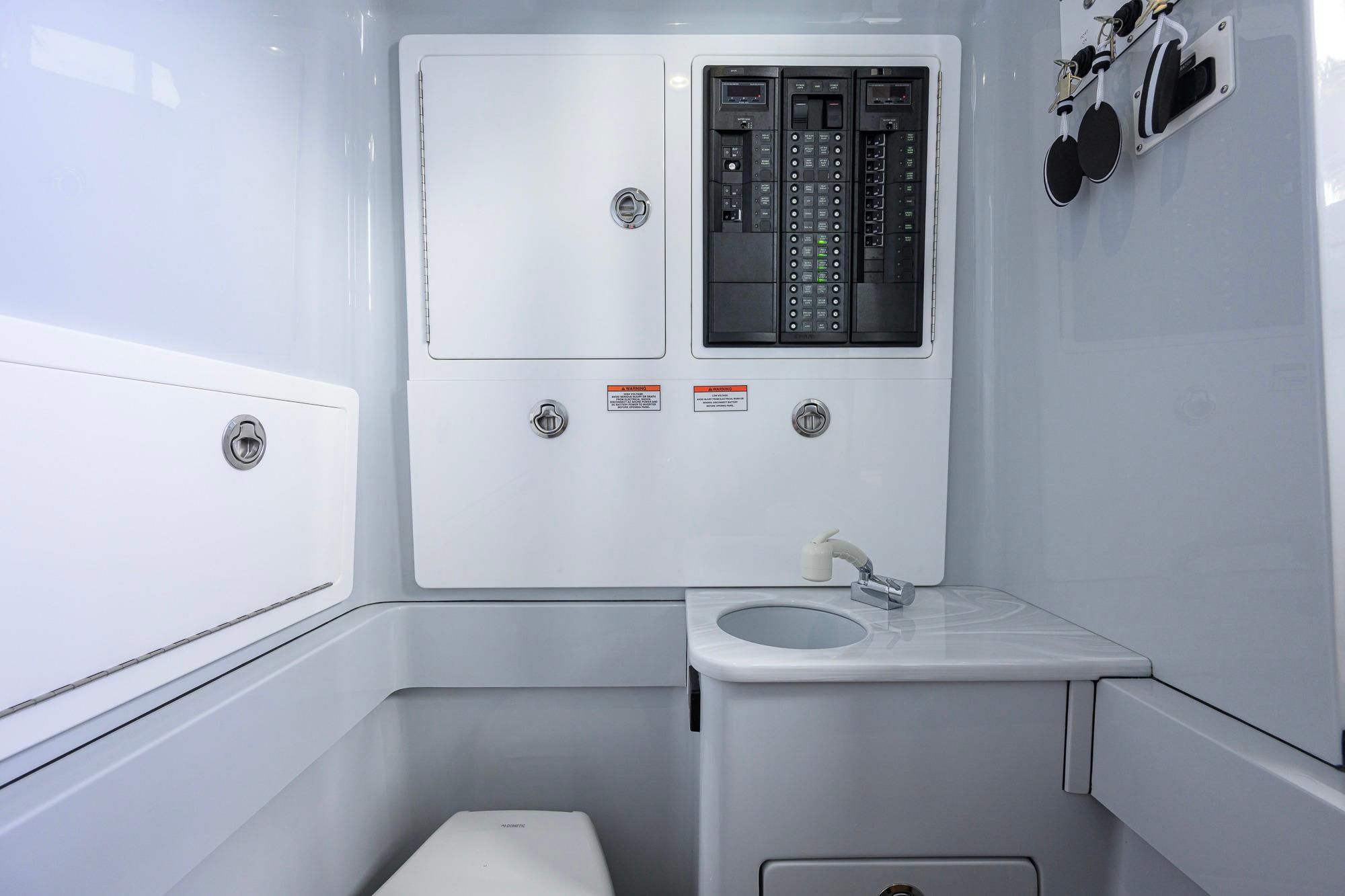 Interior of 2026 Valhalla Boatworks V-37, featuring control panels and compact sink area.