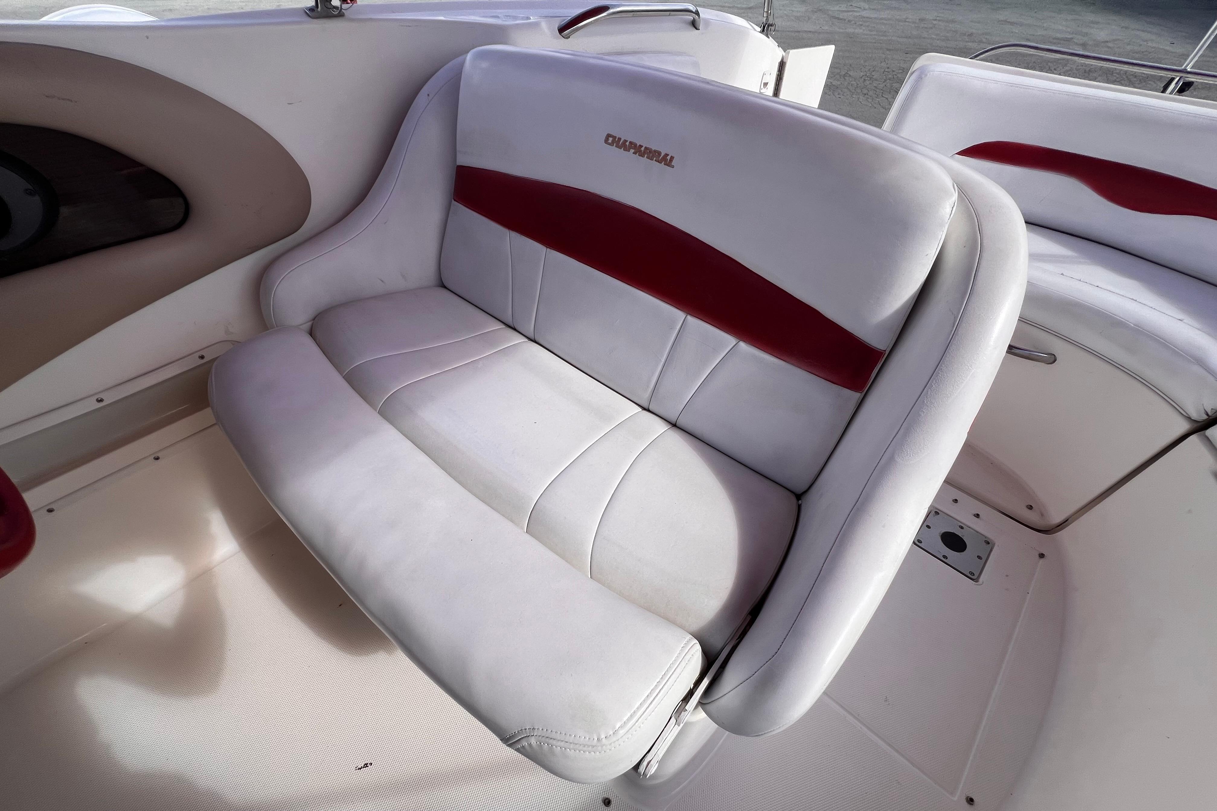 2002 Chaparral 232 Sunesta boat seat with white and red upholstery.