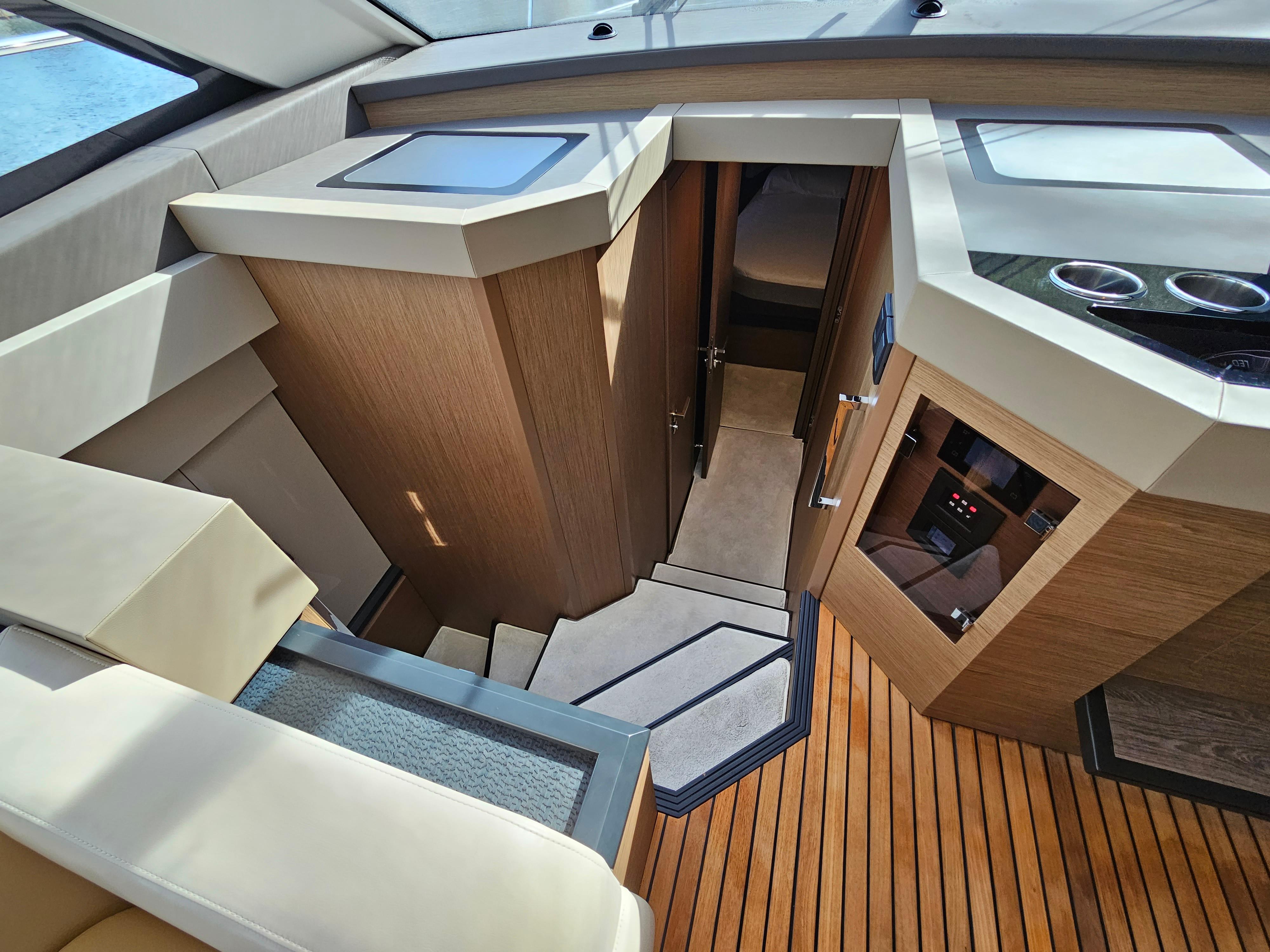Interior view of 2021 Beneteau Monte Carlo 52 yacht, featuring elegant wood finishes and modern design.