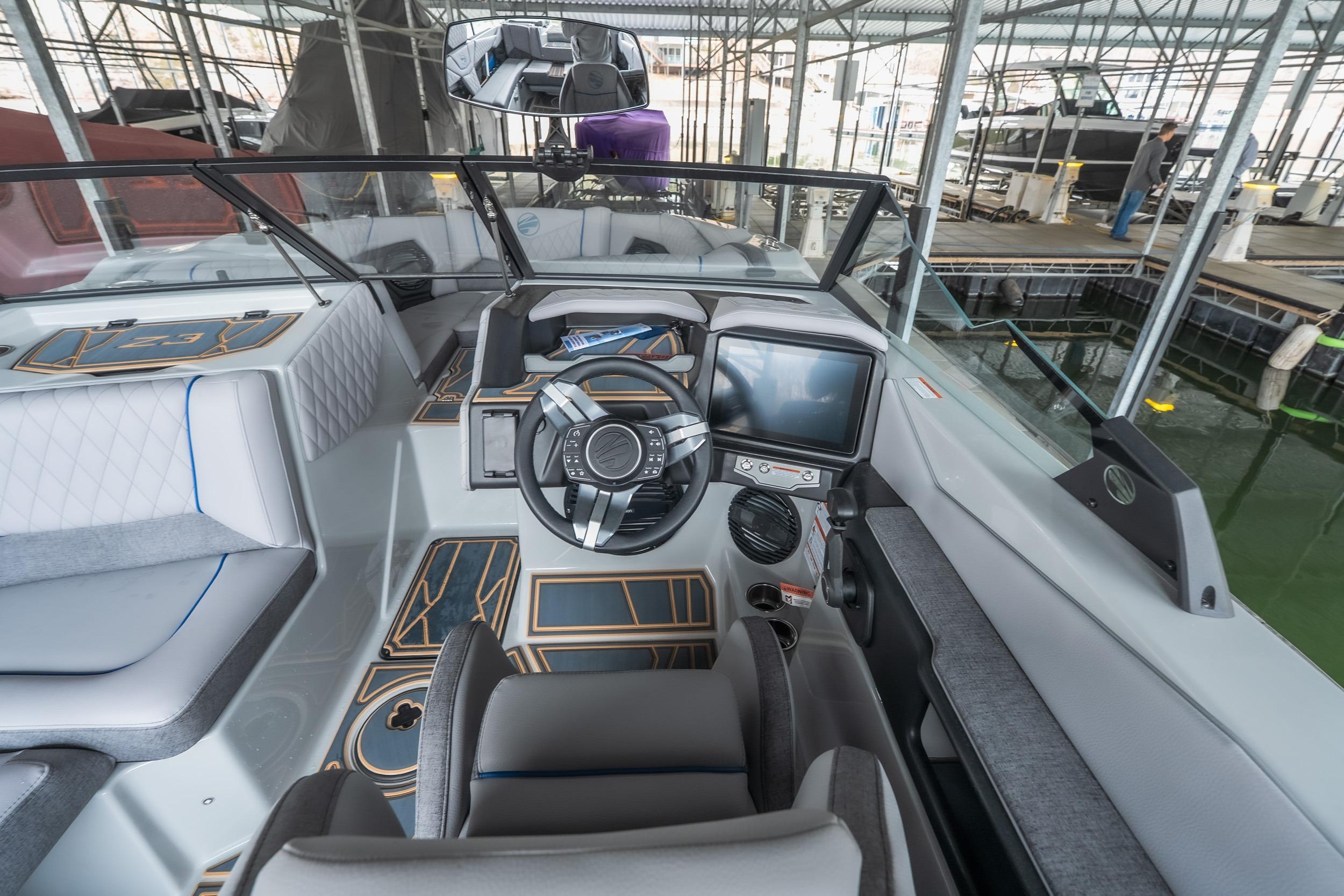 2026 Tigé Z3 boat interior with modern dashboard and sleek design in marina setting.