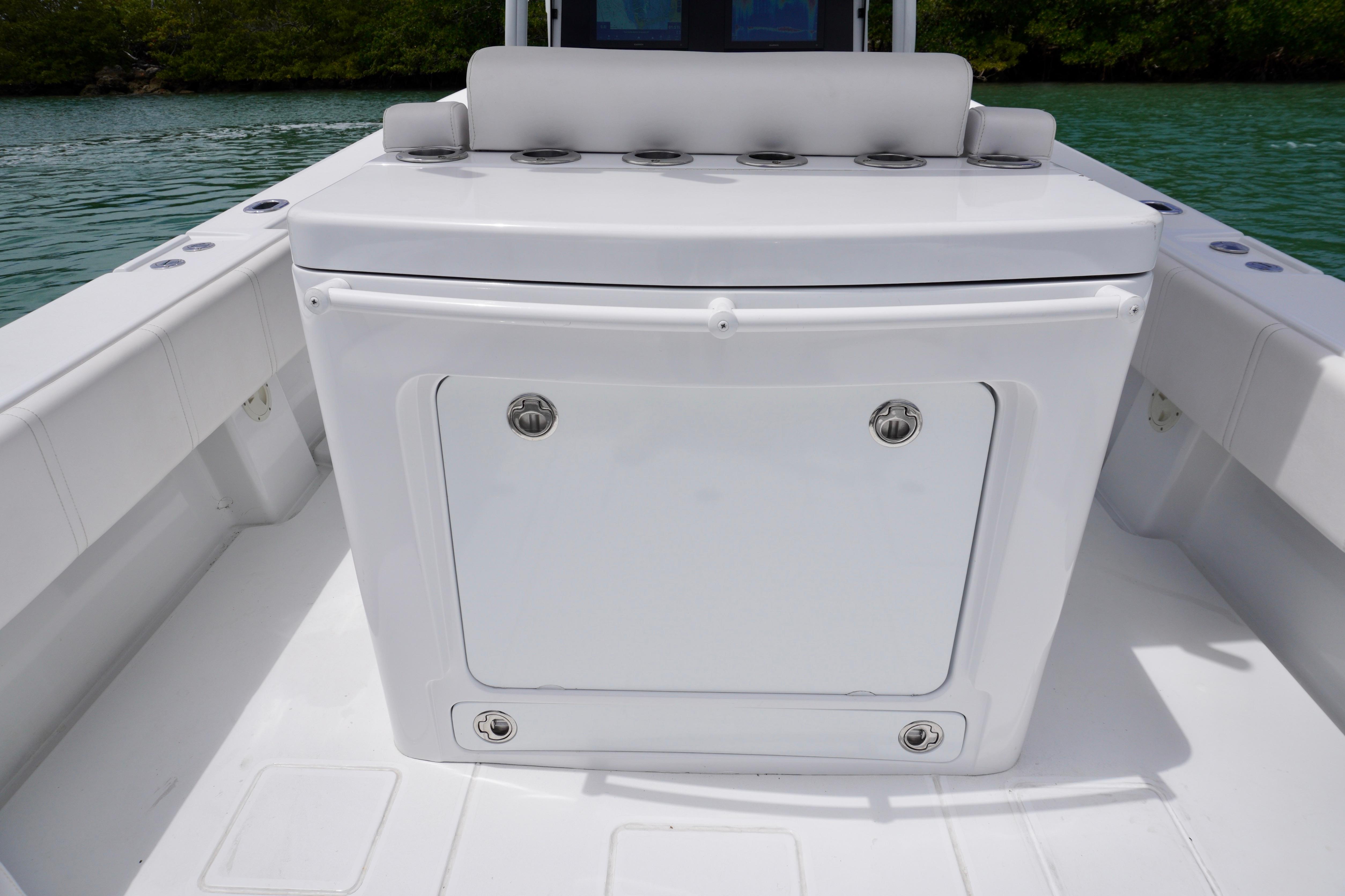 2013 Contender 35 LS boat interior with storage compartment, white seating, and rod holders.