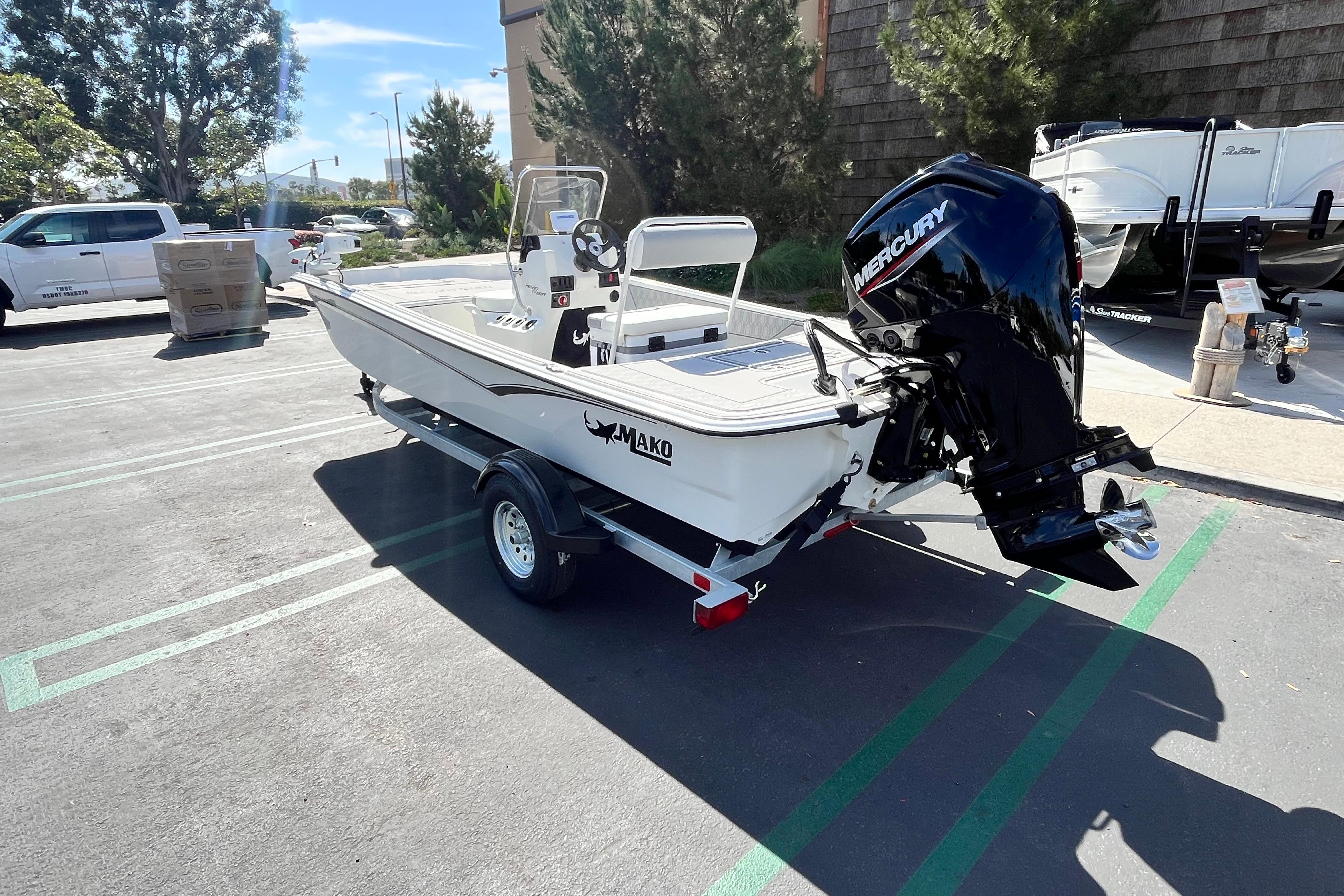 2026 Mako Pro Skiff 17 CC boat with Mercury engine in parking lot.