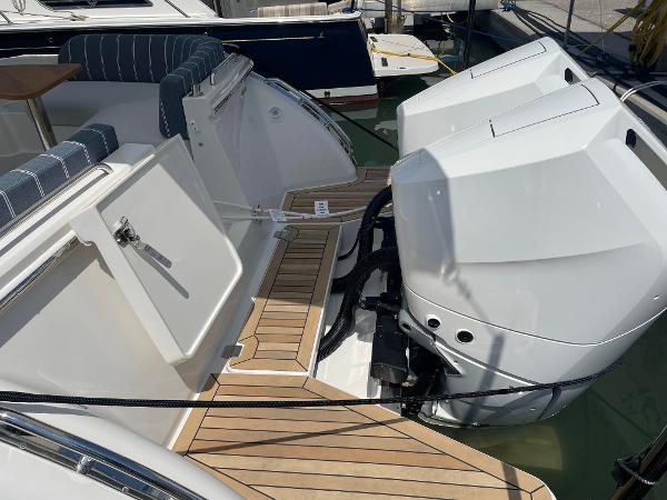 Back Cove 34O 2024 model with dual outboard engines and teak deck.
