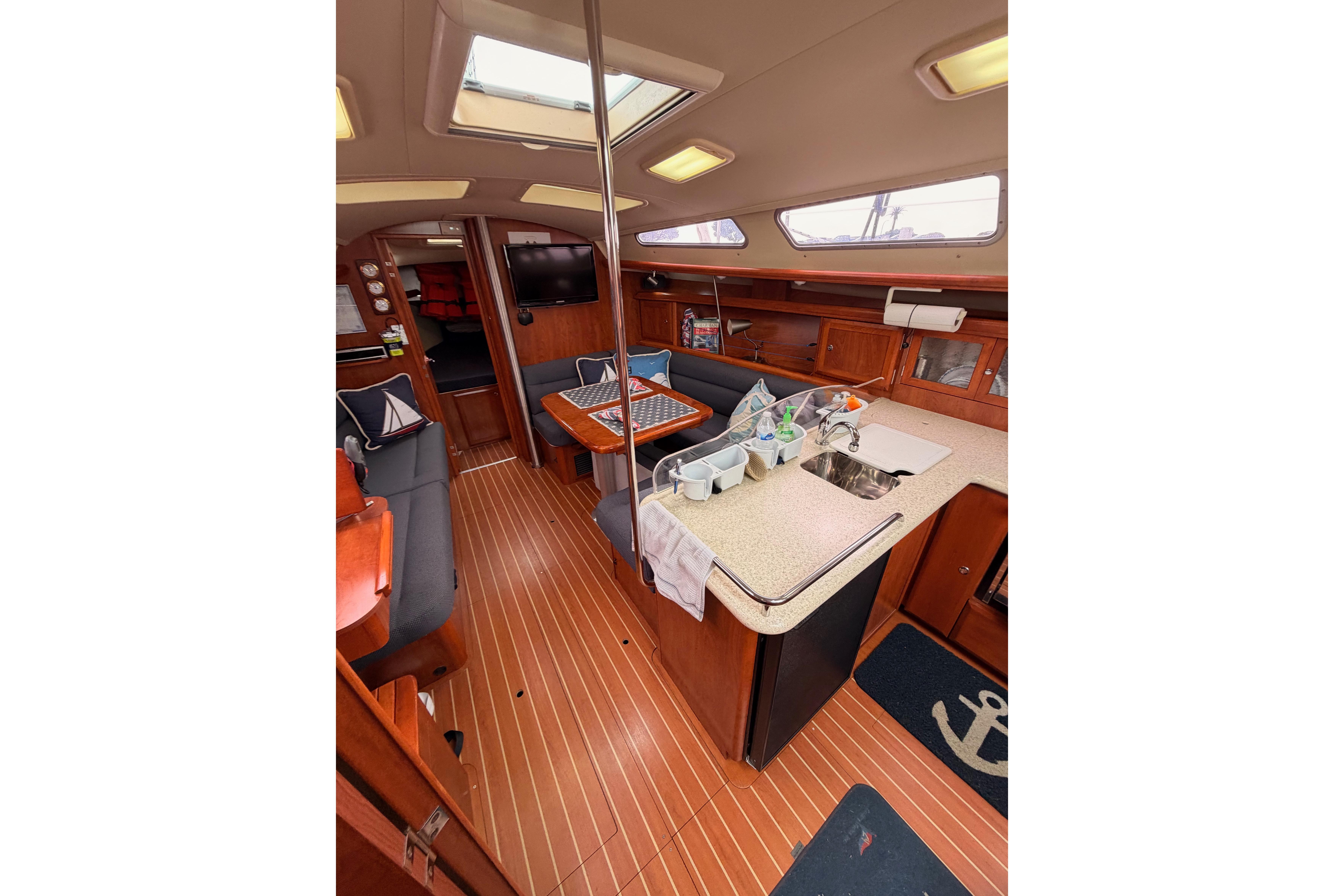 Interior of 2009 Hunter 38 sailboat with wood flooring and modern amenities.