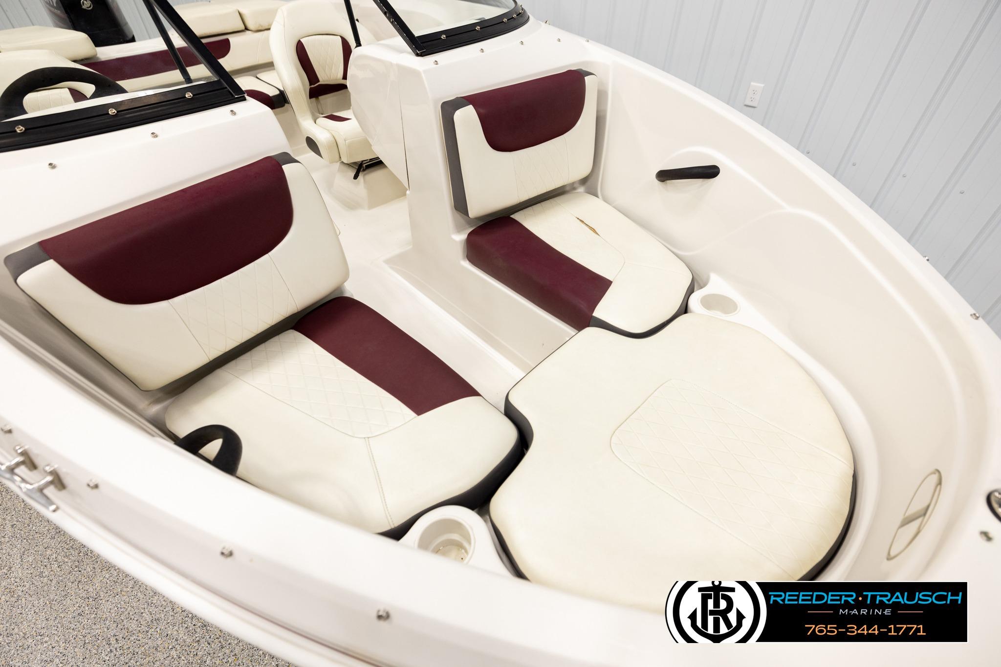 Interior of a 2016 Tahoe 450 TS boat with maroon and white seating.