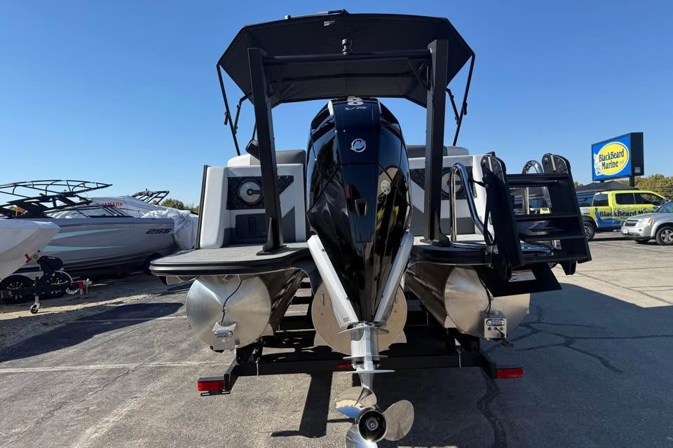 Alera M 25Q 2026 pontoon boat with powerful outboard motor at marina.