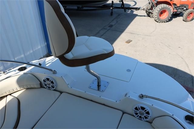A modern seat on a boat with speakers and cushioned seating.