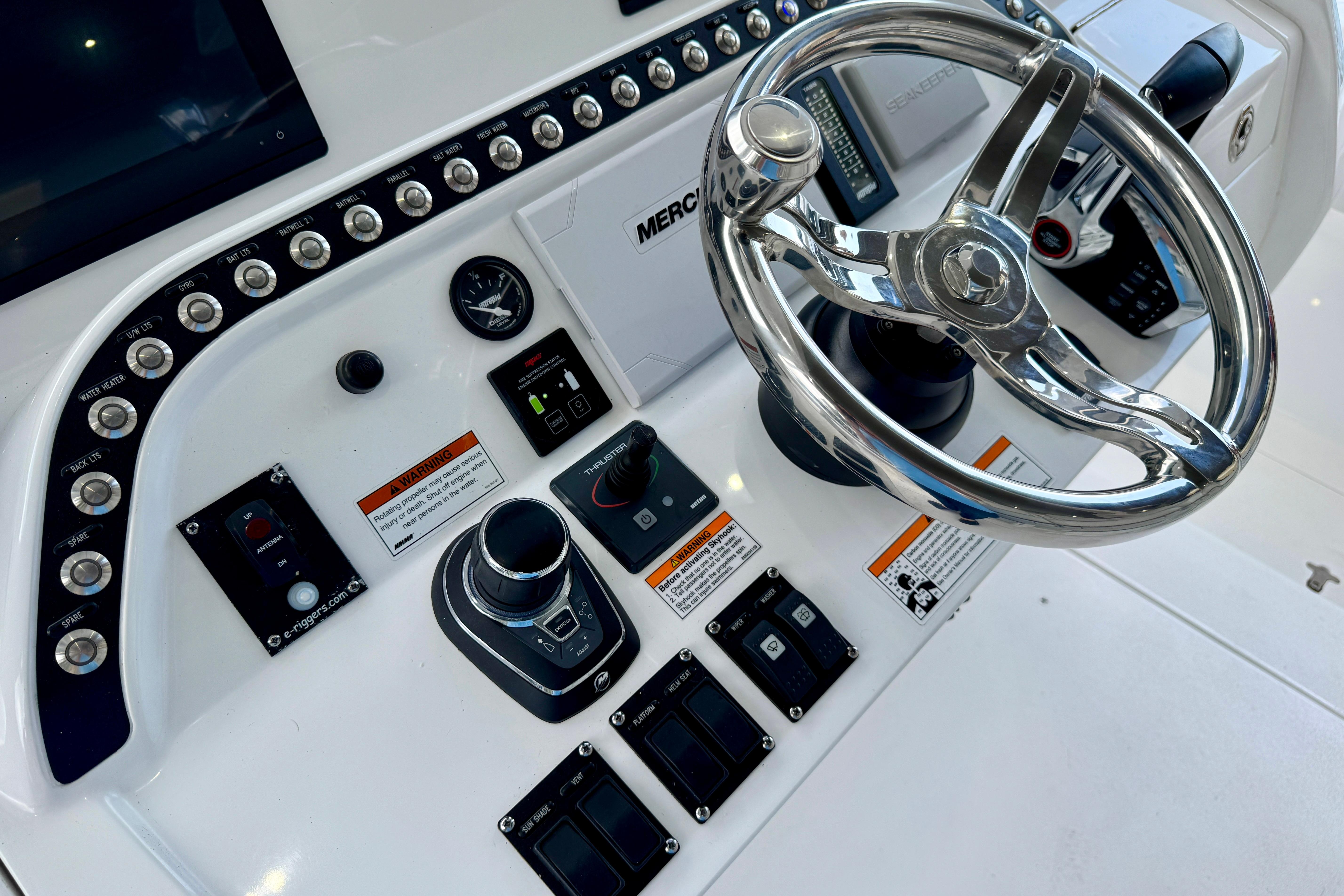 2024 Intrepid 427 Nomad SE boat dashboard with steering wheel and controls.