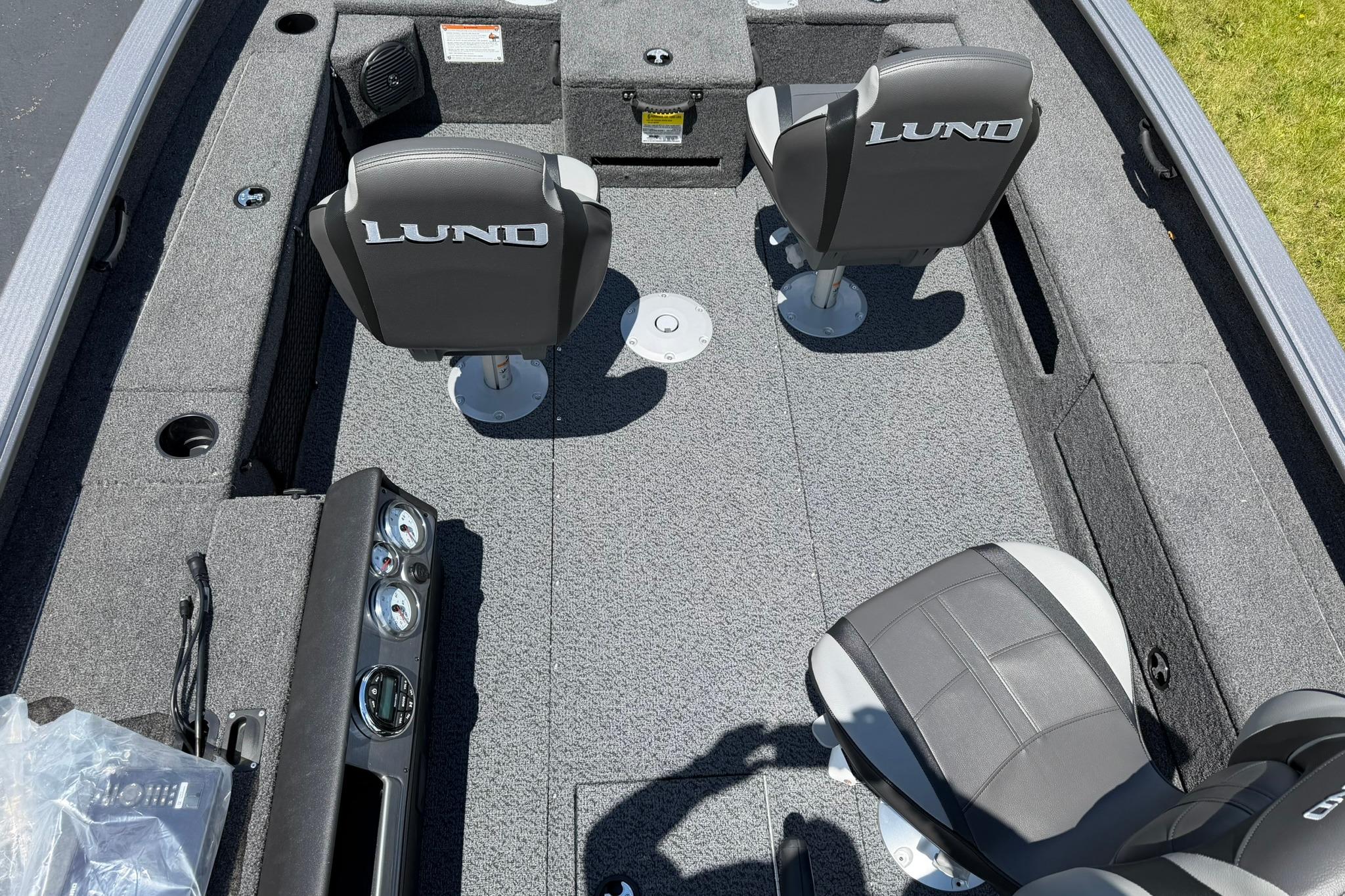 2027 Lund 1875 Pro Guide boat interior with two seats and control panel.