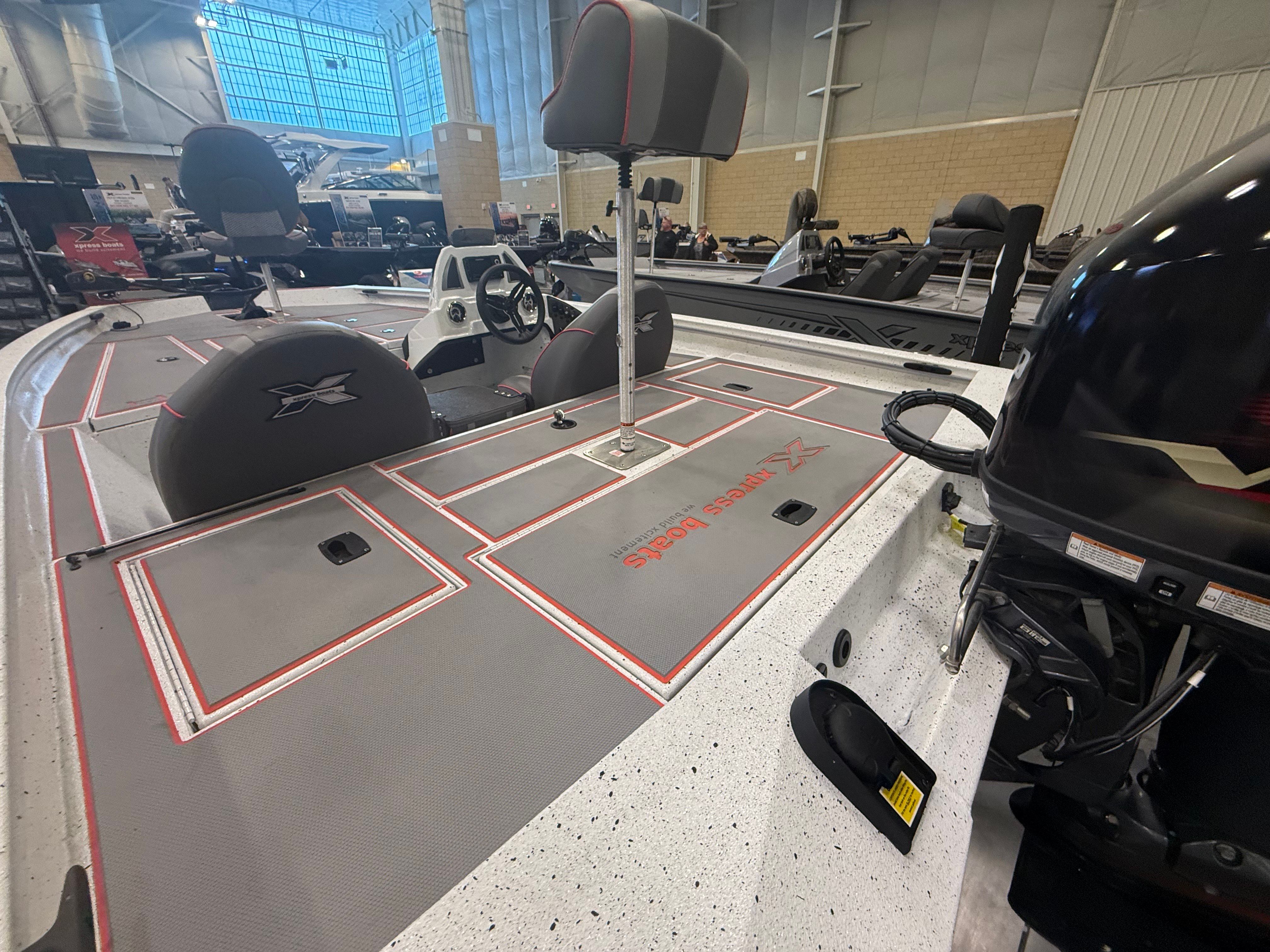 2024 Xpress H17 boat with gray deck and red accents.